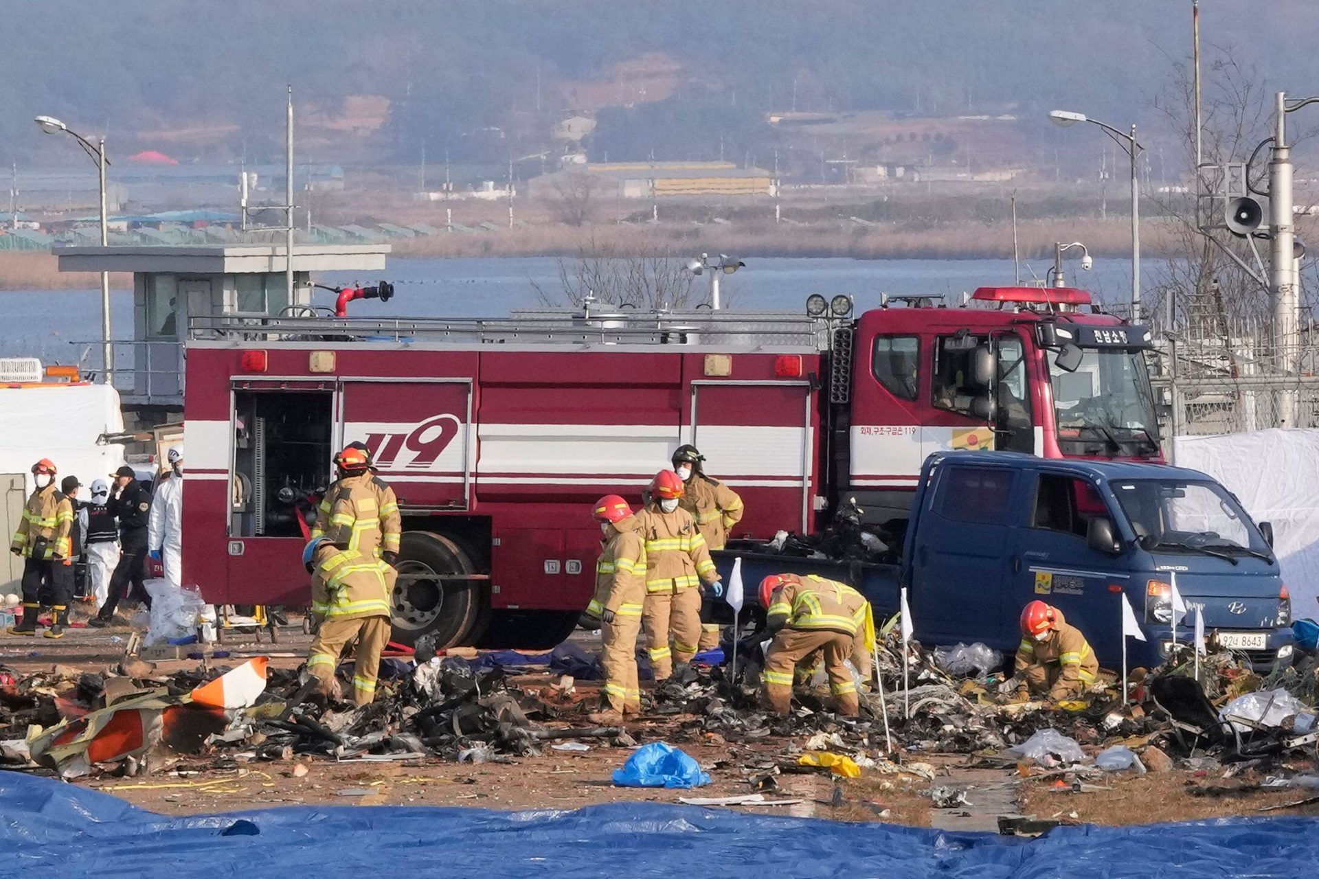 Rescue team members work at Muan International Airport in Muan, South Korea.