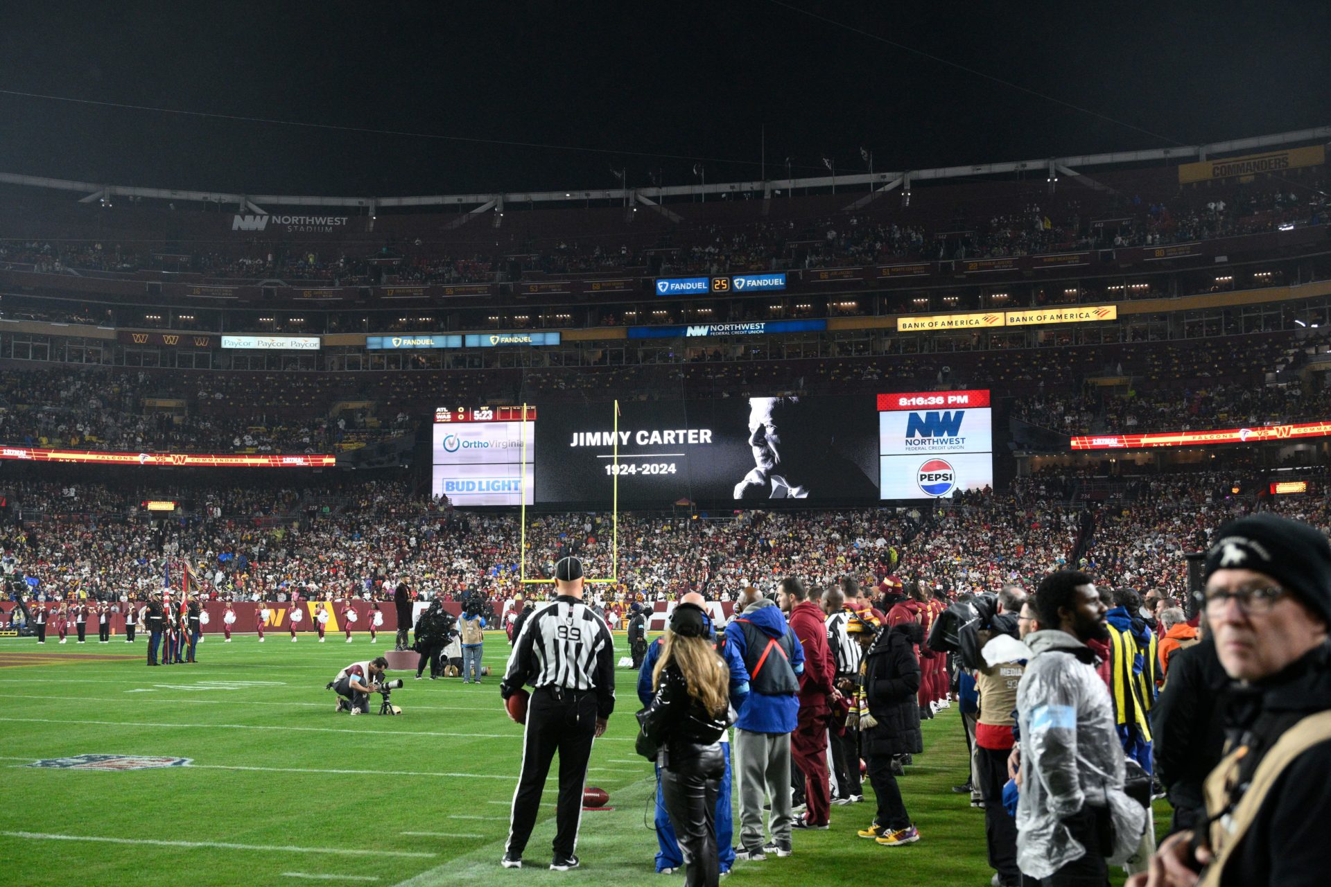 A video tribute to former President Jimmy Carter is seen before an NFL football game between the Washington Commanders and the Atlanta Falcons.