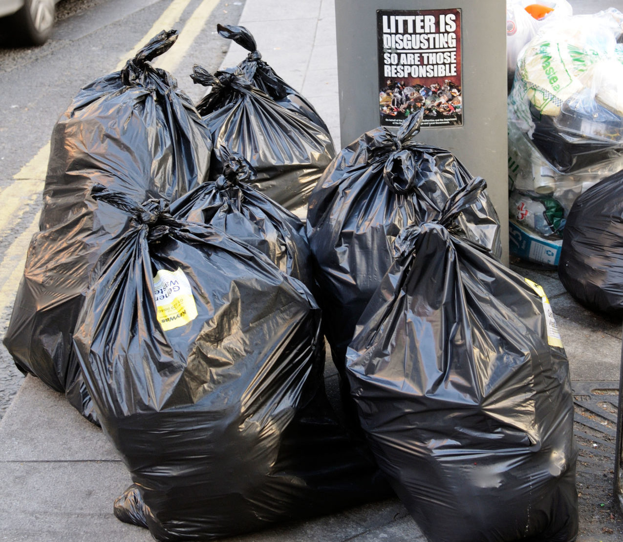 Rubbish bags await collection by Council services on the roadside in a central Dublin Street Ireland