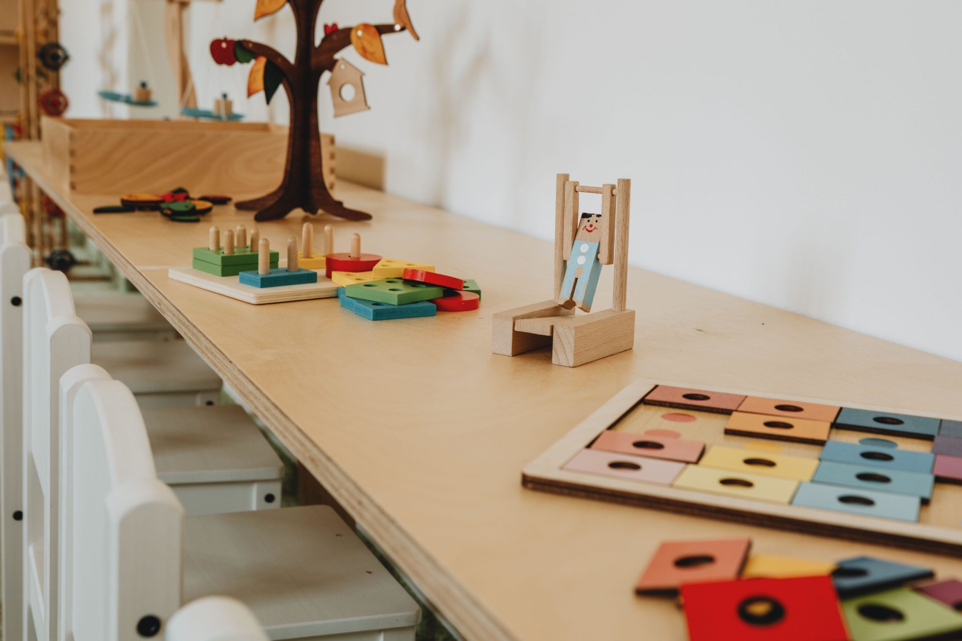 A table in a classroom covered with toys