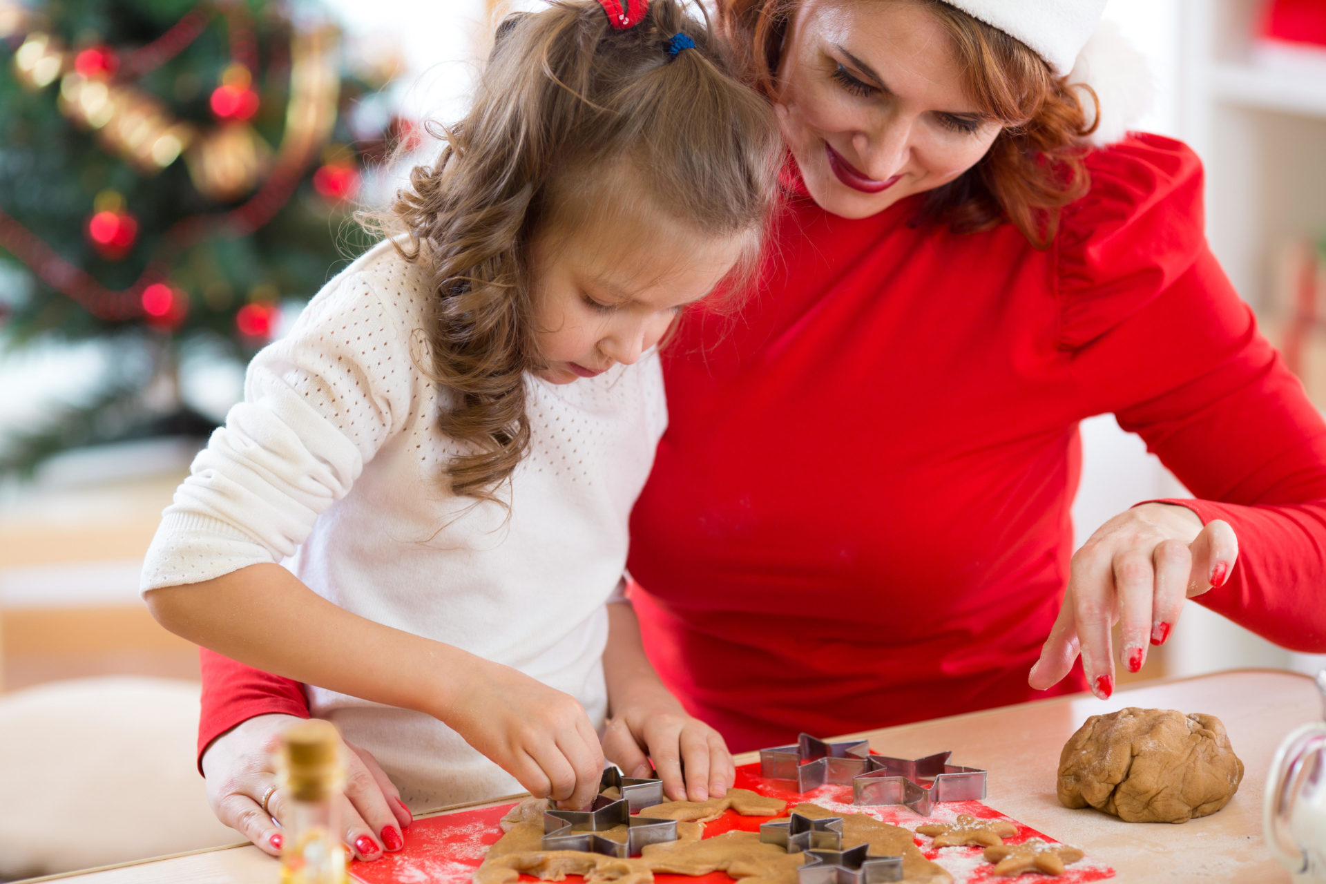 Woman and child cutting out Christmas cookies