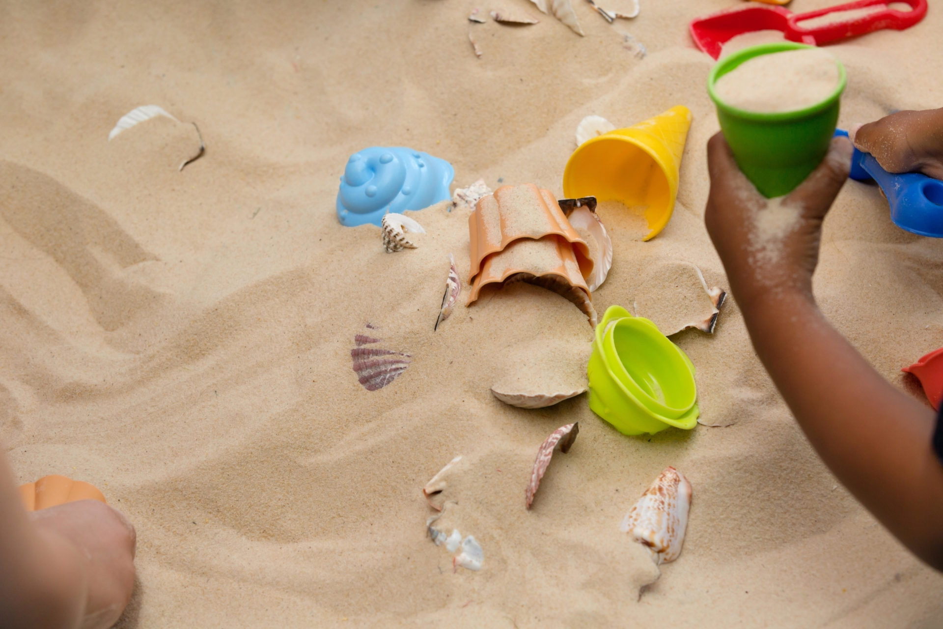 Little Hands Exploring The Beach Sand. Image: Alamy