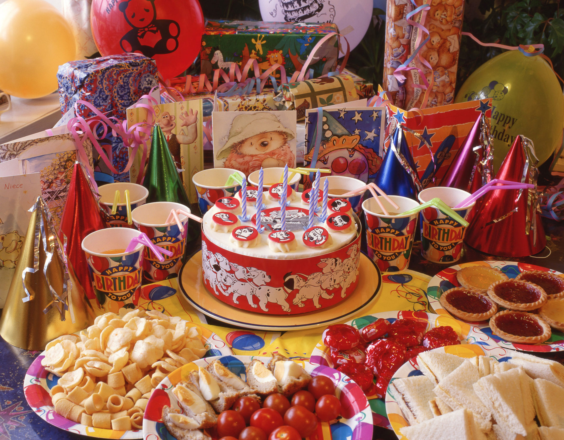 Children's birthday cake and party food spread.