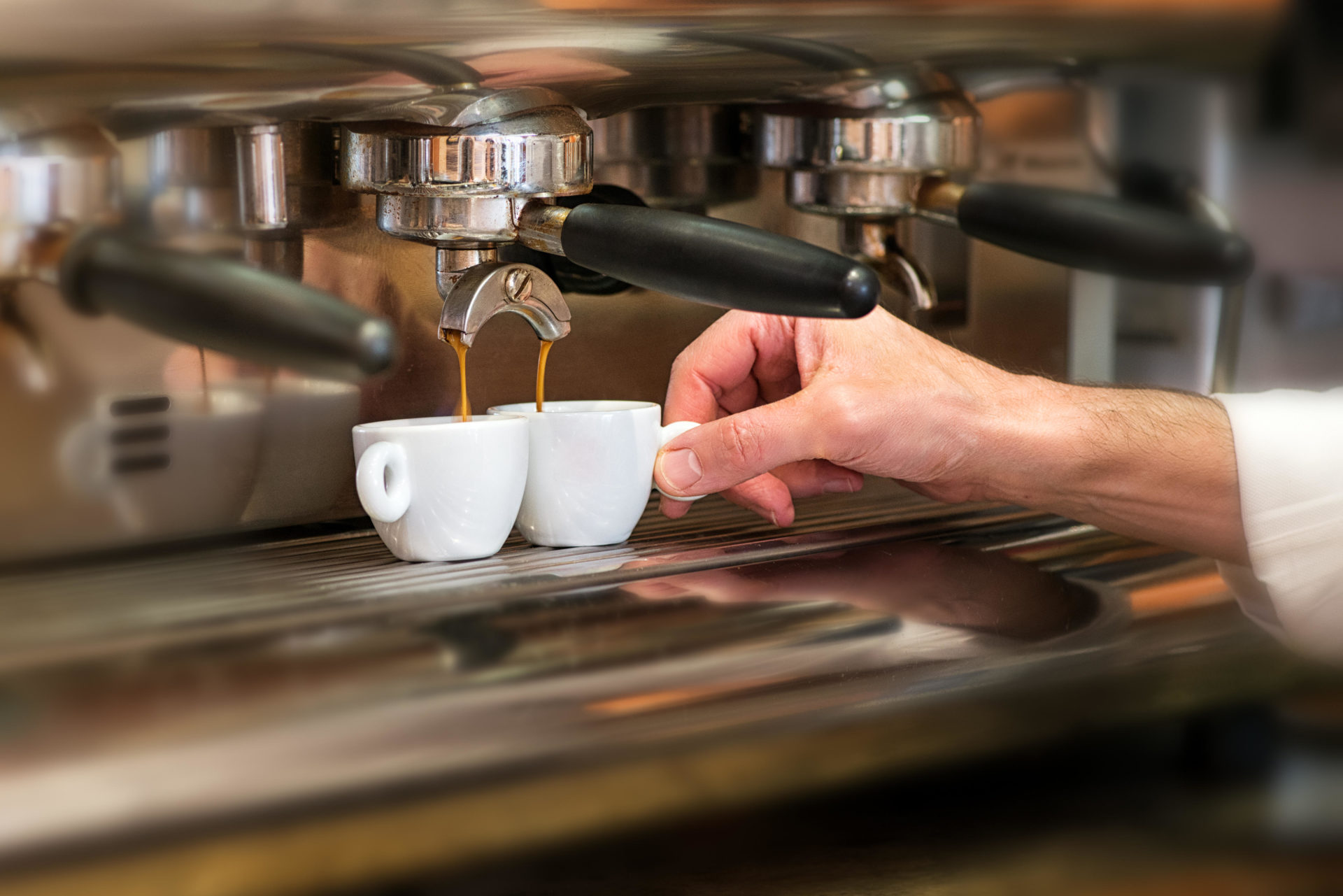 Close up view of the hand of a man working in a coffee house