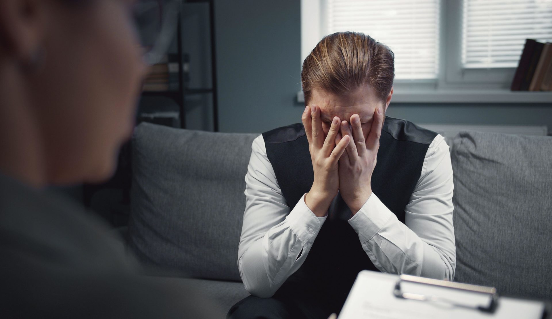 A distressed man receives psychotherapy
