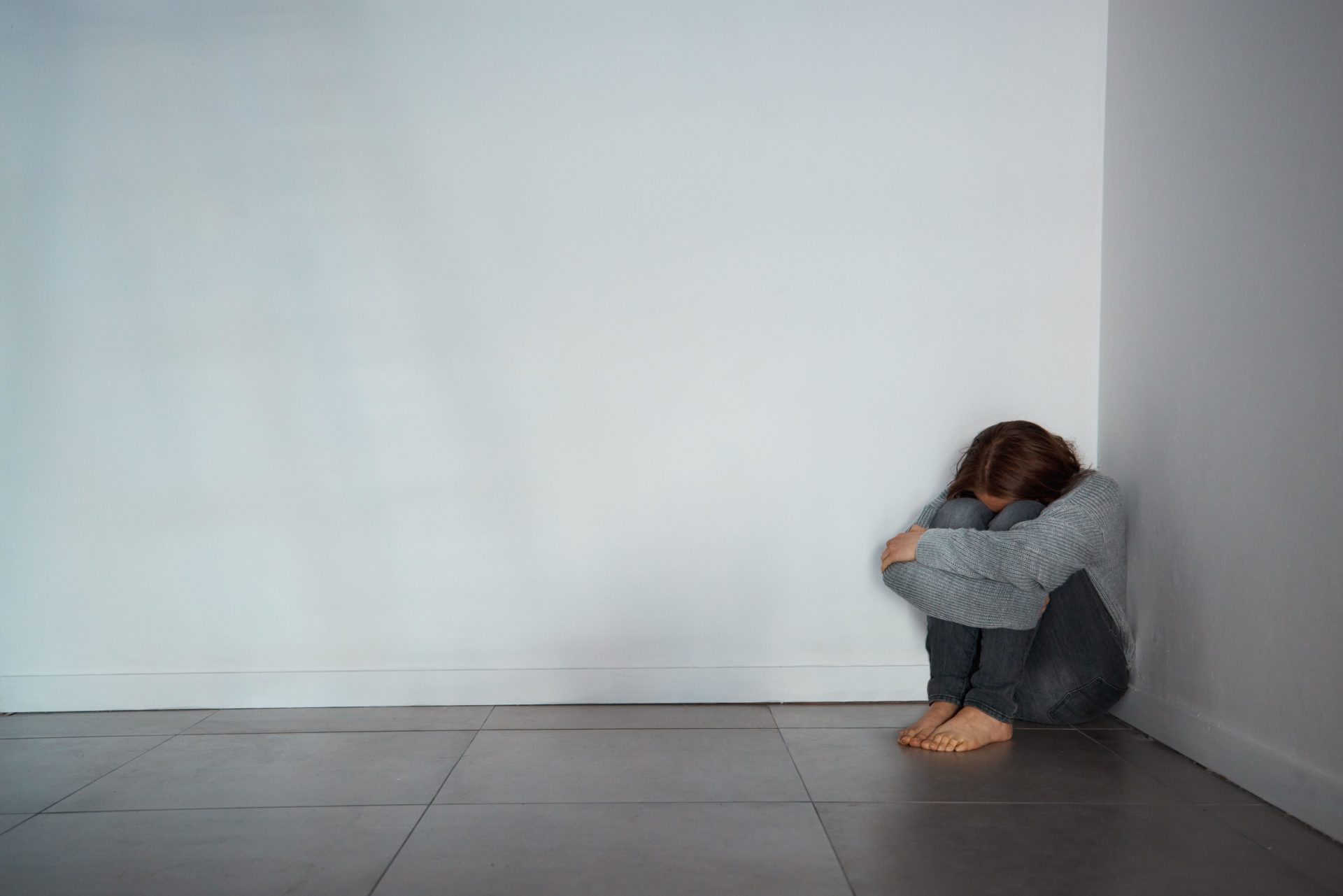 Woman on the floor crying. Image: Alamy