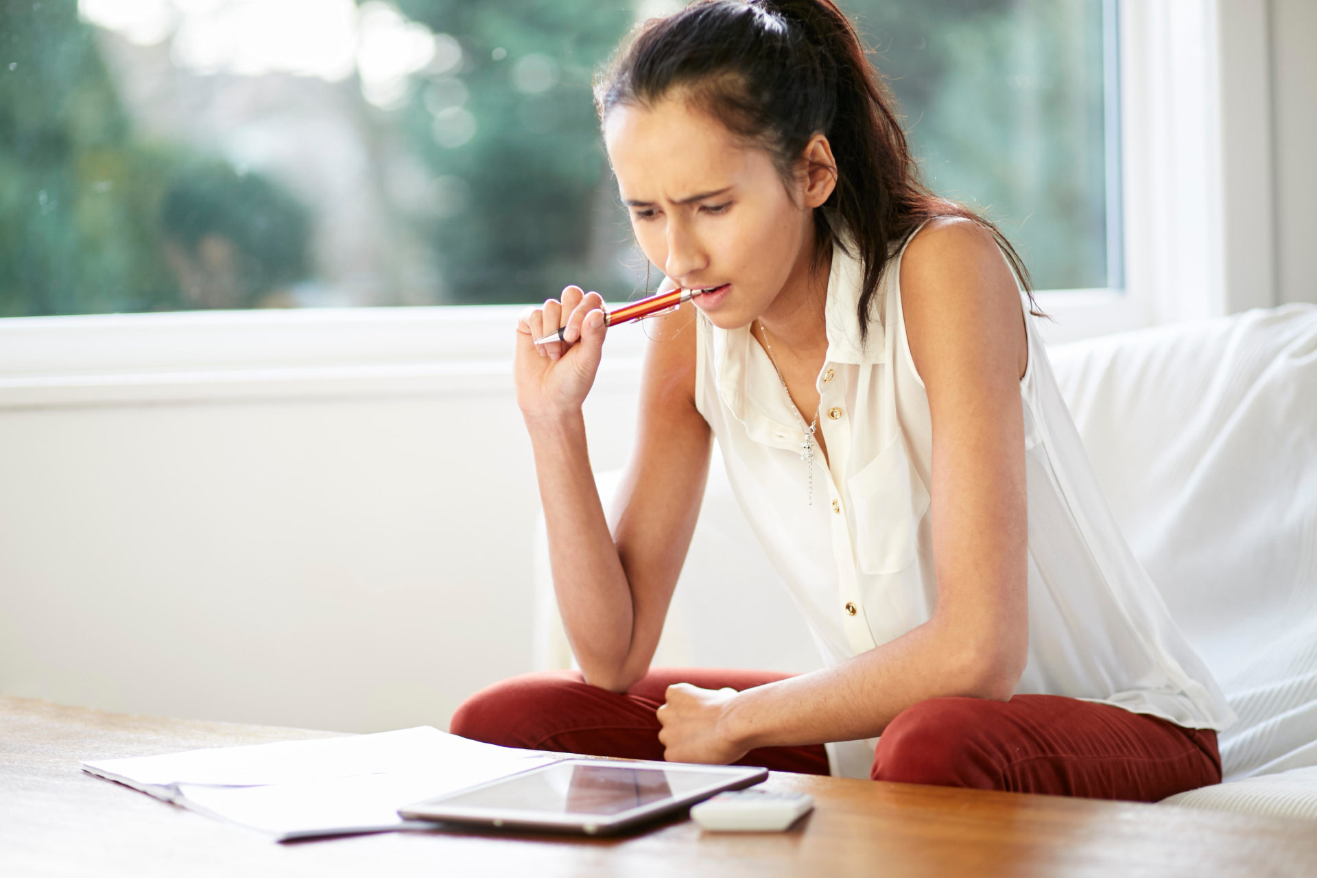 Girl working out finances. 