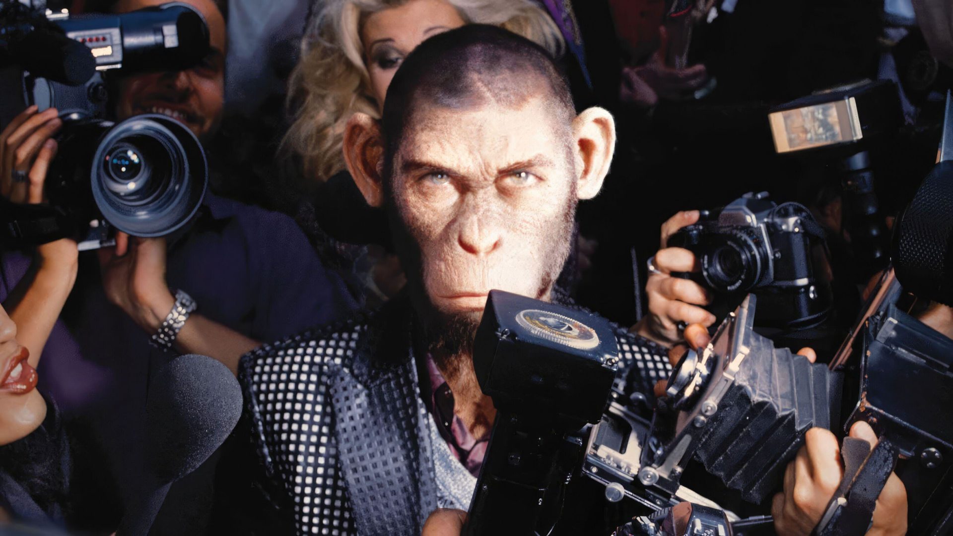 A poster for Better Man with a monkey portraying Robbie Williams, surrounded by cameras