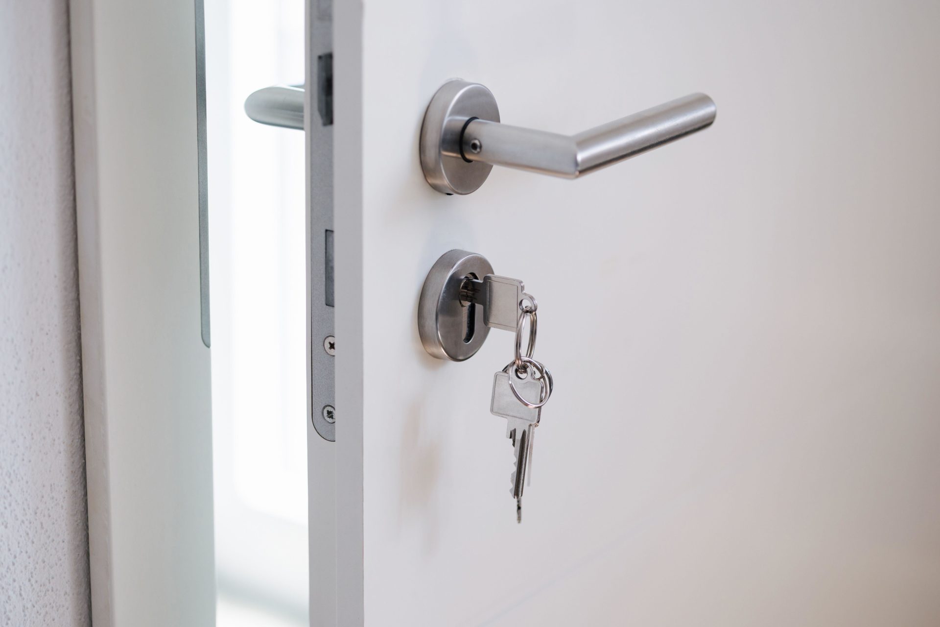 Silver keys hanging in a modern door lock. Image: Alamy