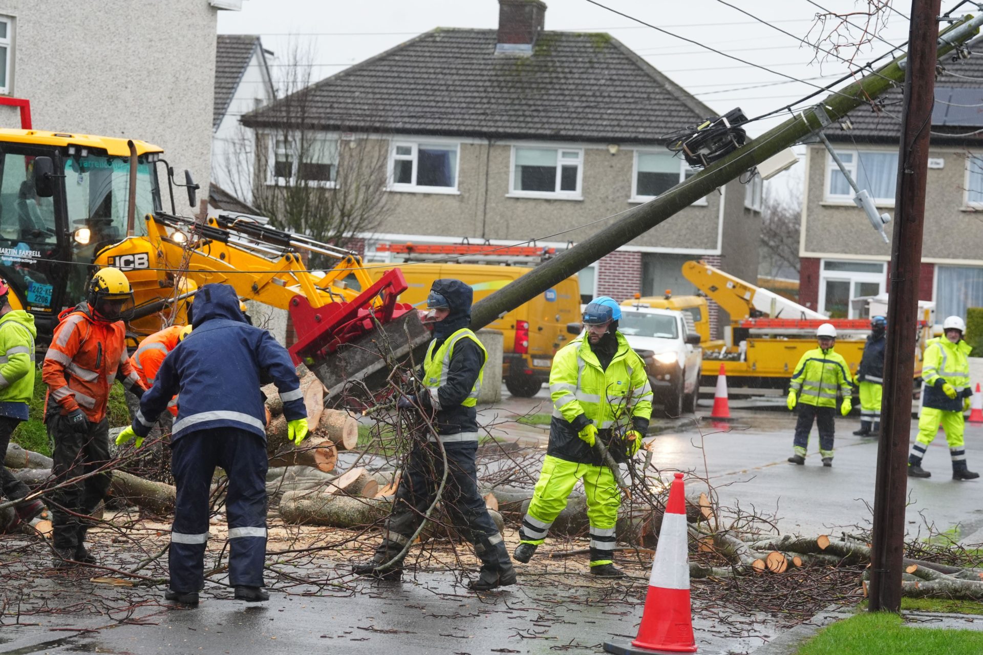 Workers clearing a fallen tree on Grove Park Drive in Dublin as ESB networks continue to reconnect homes and businesses across the country after Storm Eowyn wreaked havoc throughout the country.