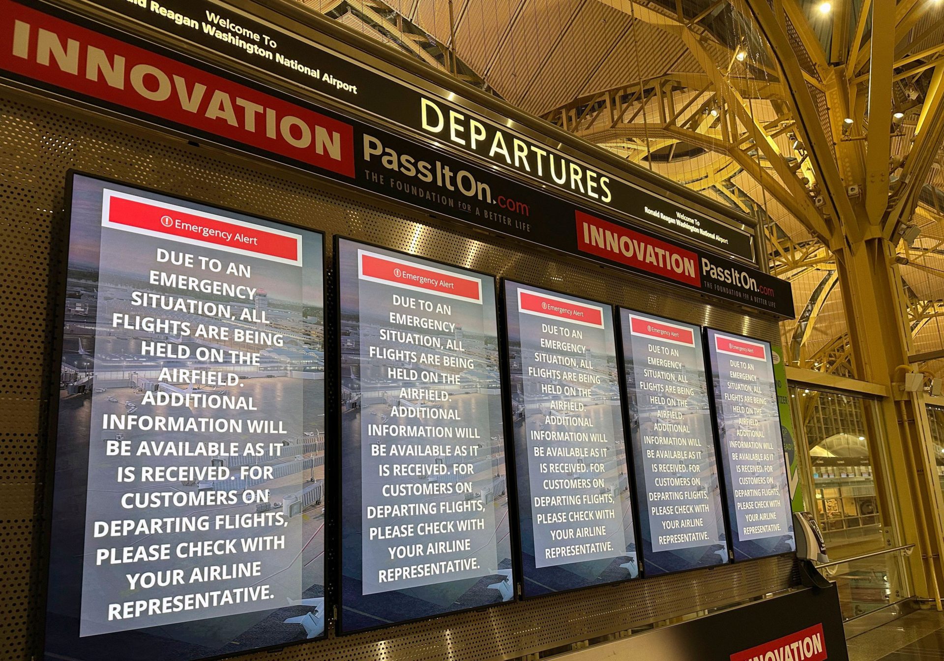 2SAGG72 Departure signs display an "Emergency Alert" in the terminal at Ronald Reagan Washington National Airport, Wednesday night, Jan. 29, 2025, in Arlington, Va. A jet with 60 passengers and four crew members aboard collided with an Army helicopter while landing at Ronald Reagan National Airport near Washington, prompting a large search-and-rescue operation in the nearby Potomac River. (AP Photo/Jeannie Ohm)