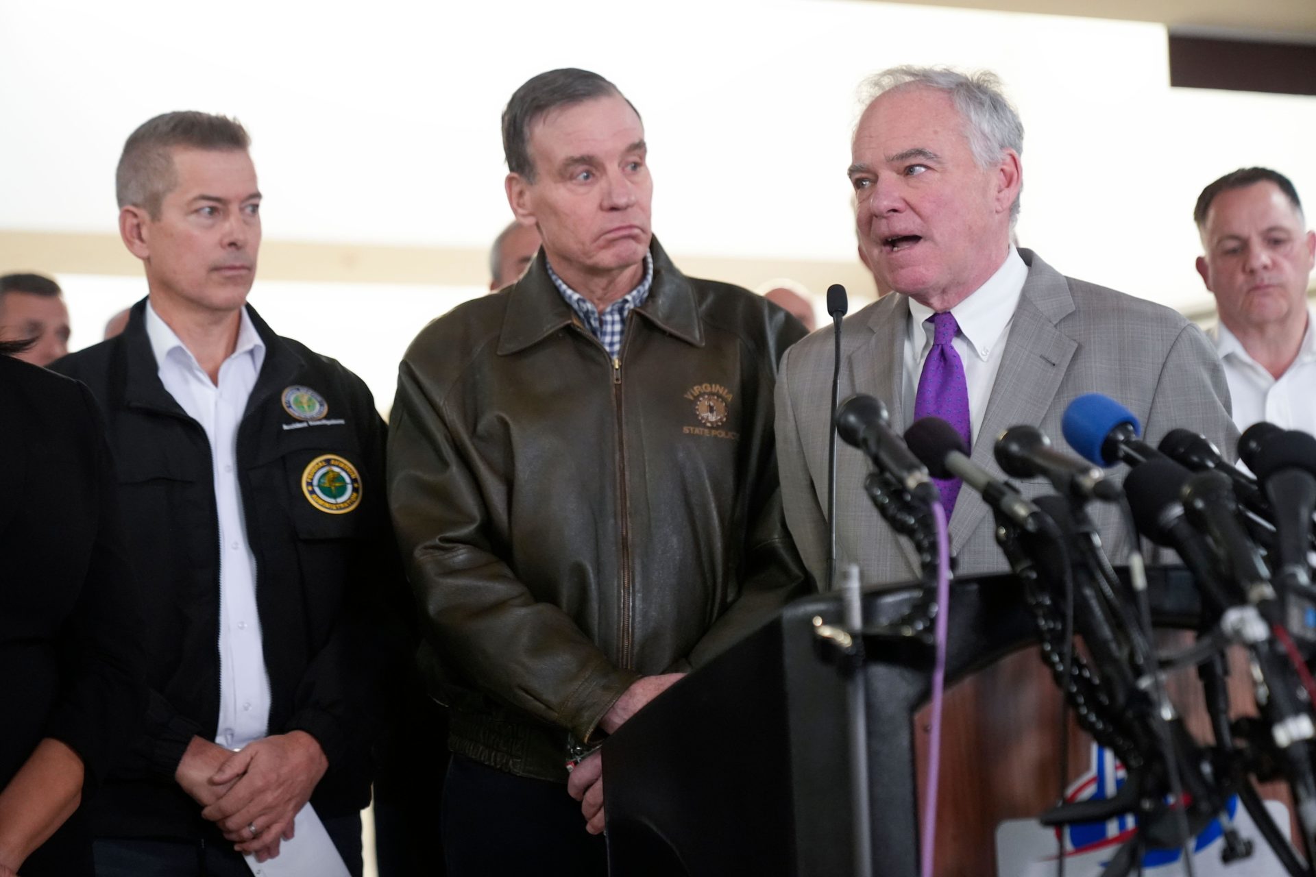 2SAK203 From left, Transportation Secretary Sean Duffy, Sen. Mark Warner, D-Va. and Sen. Tim Kaine, D-Va., and other officials, during a news conference on the Wednesday night crash of an American Airlines jet that collided with an Army helicopter, at Ronald Reagan Washington National Airport, Thursday morning, Jan. 30, 2025, in Arlington, Va. (AP Photo/Mark Schiefelbein)