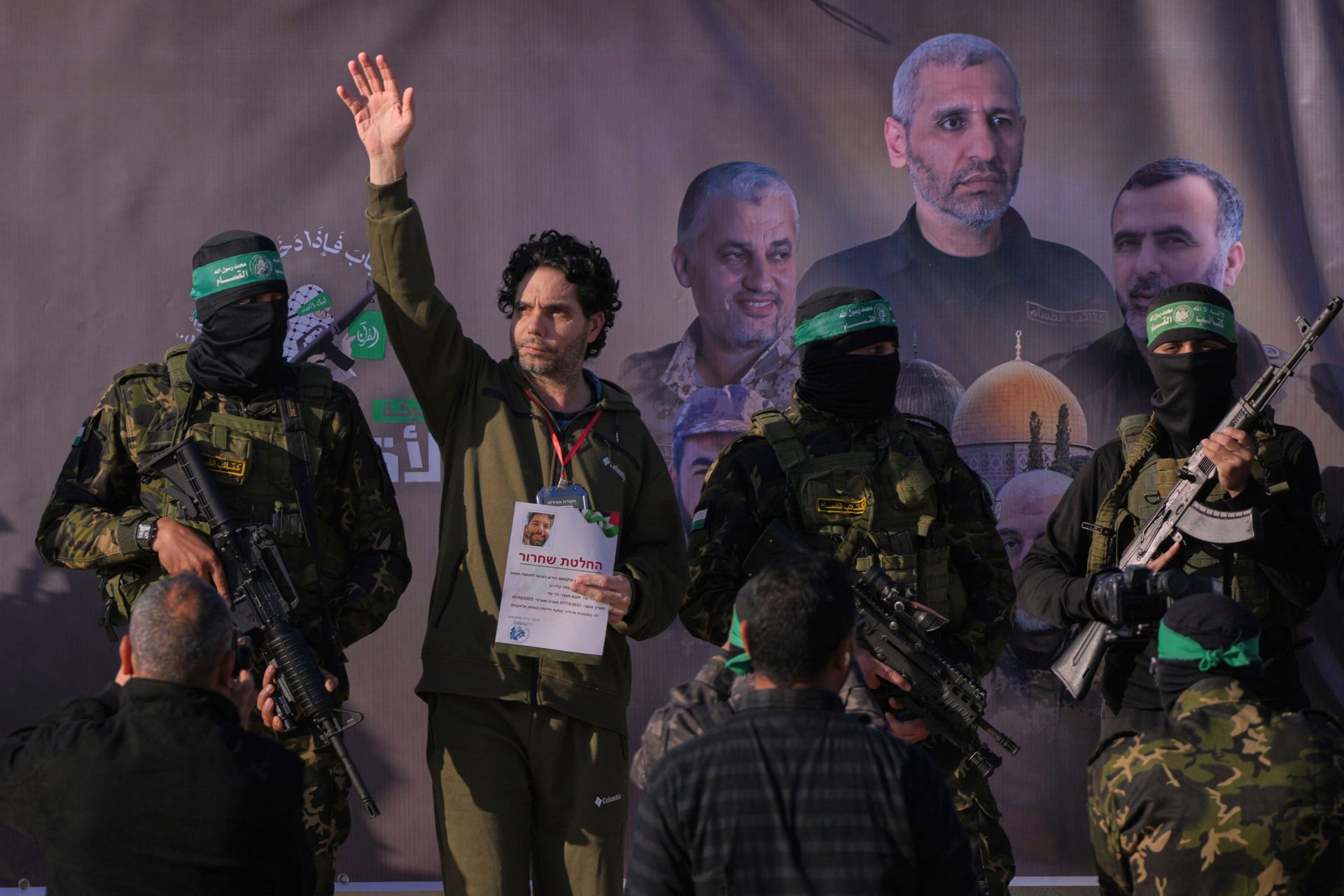 Israeli Ofer Kalderon who has been held hostage by Hamas in Gaza since October 7, 2023, waves before being handed over to the Red Cross by Hamas fighters in Khan Younis, southern Gaza Strip