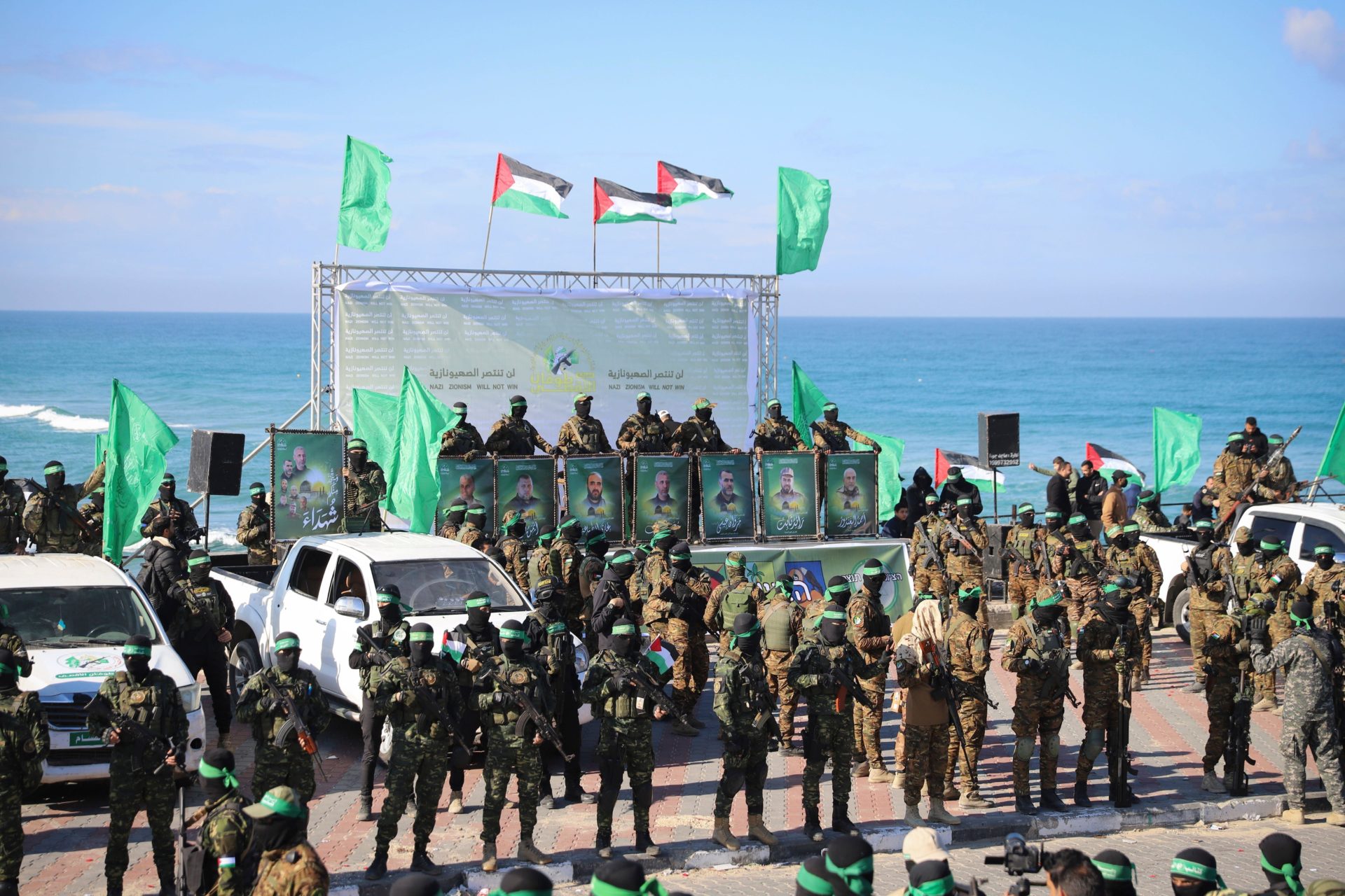 Hamas fighters deploy at the stage where the hand over of American-Israeli hostage Keith Siegel, 65, to the Red Cross will take place in Gaza City