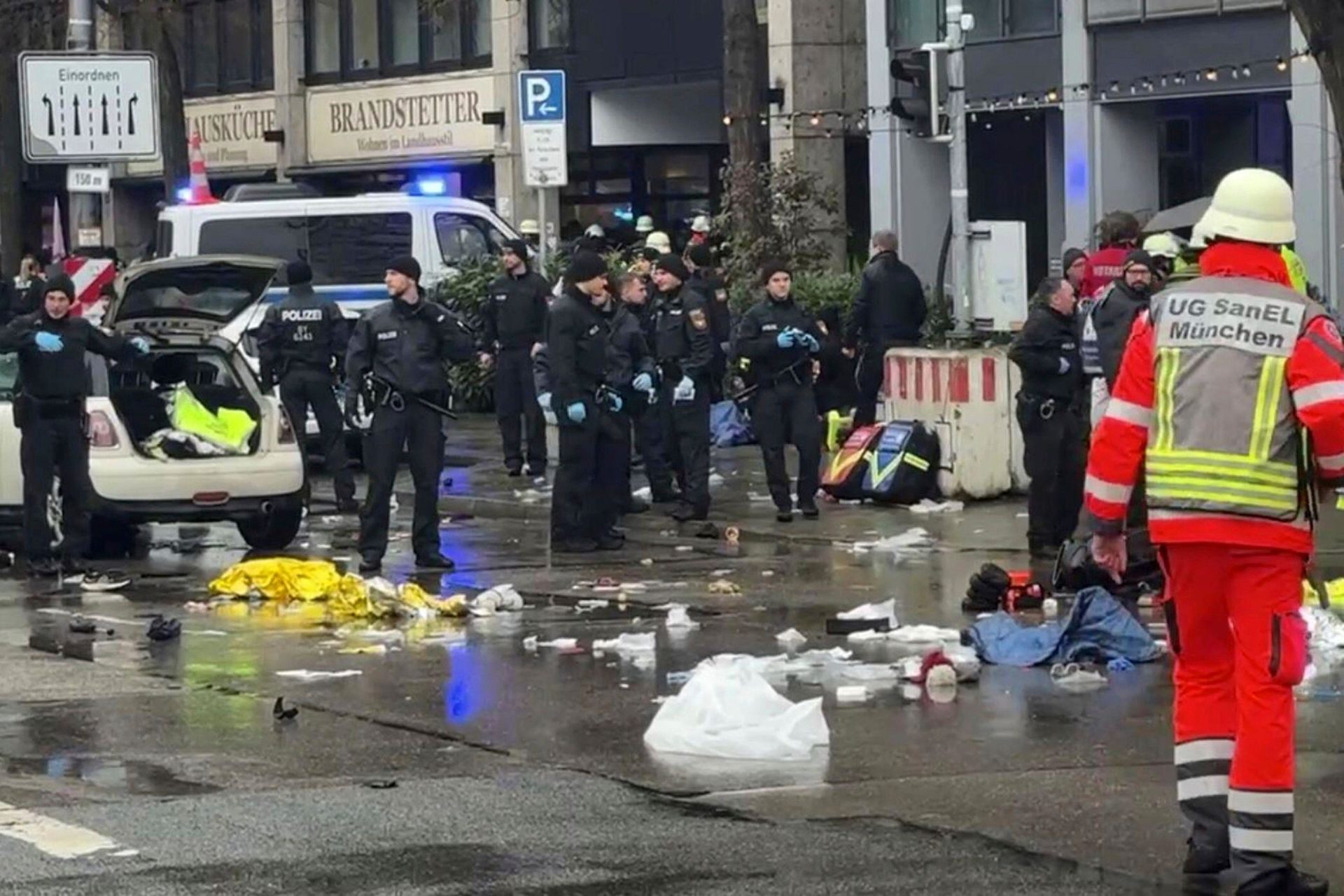 Emergency services attend the scene of an accident after a driver hit a group of people in Munich, Germany, Thursday Feb. 13, 2025. (Peter Kneffel/dpa via AP)