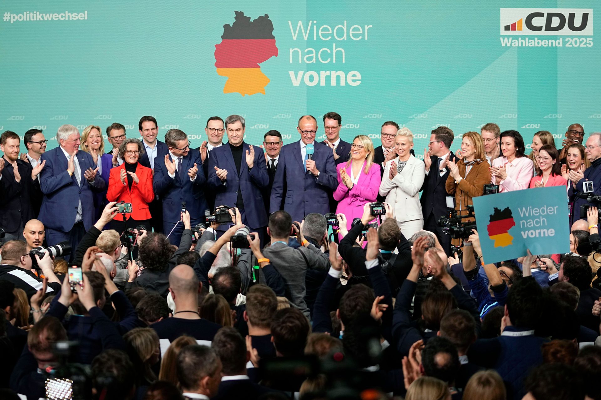 Friedrich Merz, center, the candidate of the election winner, the conservative Christian Democratic Union party, CDU, addresses supporters at the party headquarters in Berlin, Germany, Sunday, Feb. 23, 2025, after the German national election.