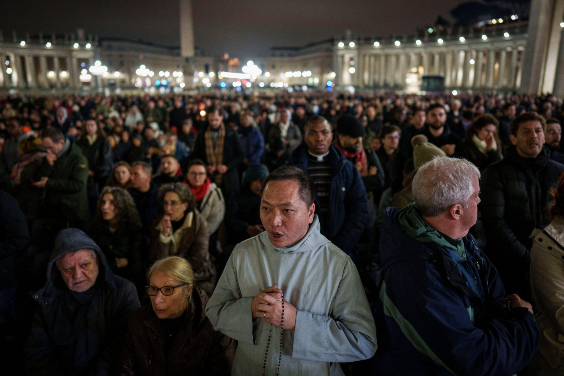 Faithful pray during a nightly rosary in St. Peter's Square at The Vatican for Pope Francis' recovery.