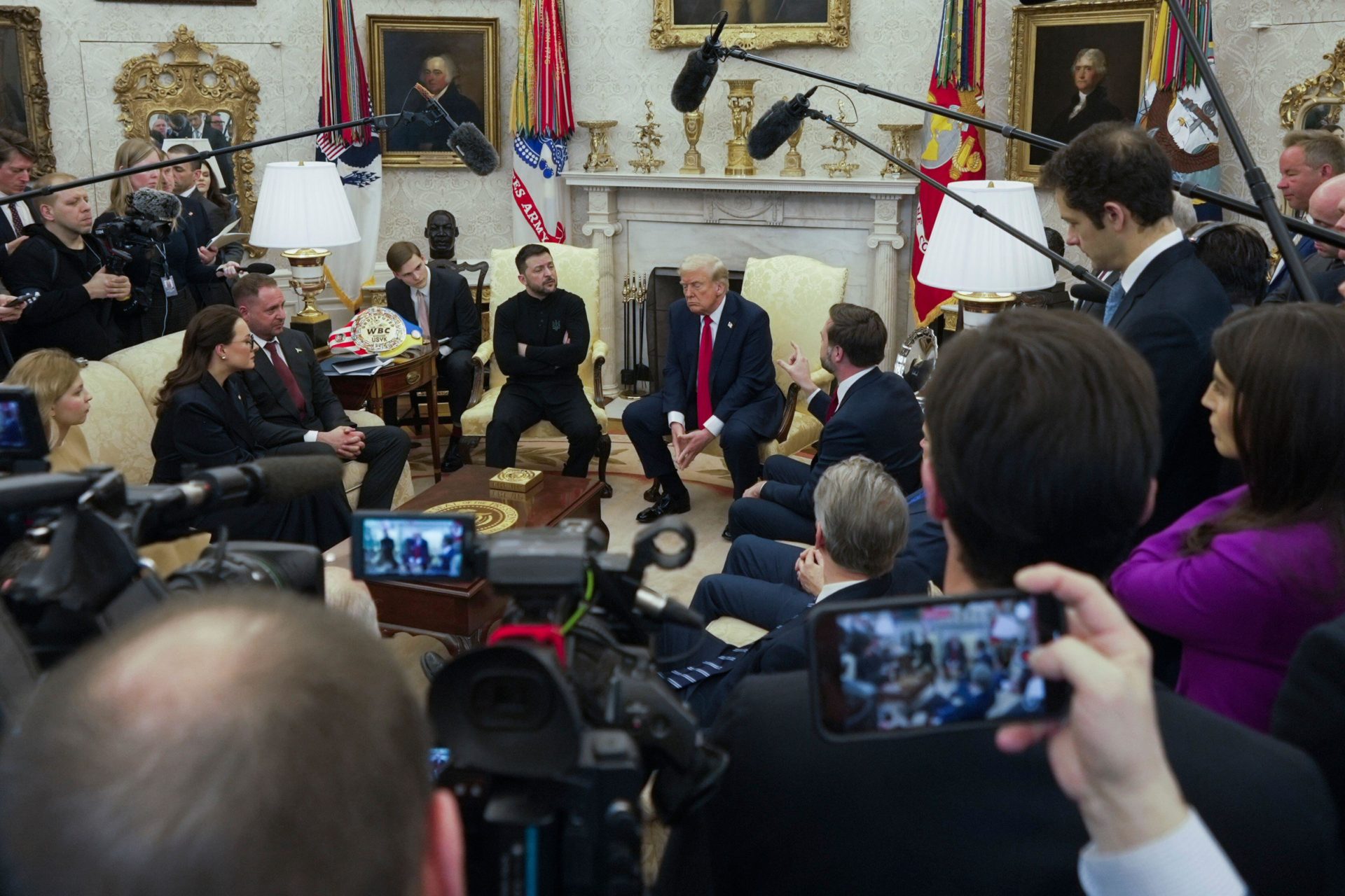 Vice President JD Vance, center right, speaks with Ukrainian President Volodymyr Zelenskyy, center left, as President Donald Trump, center, listens in the Oval Office at the White House, Friday, Feb. 28, 2025, in Washington.