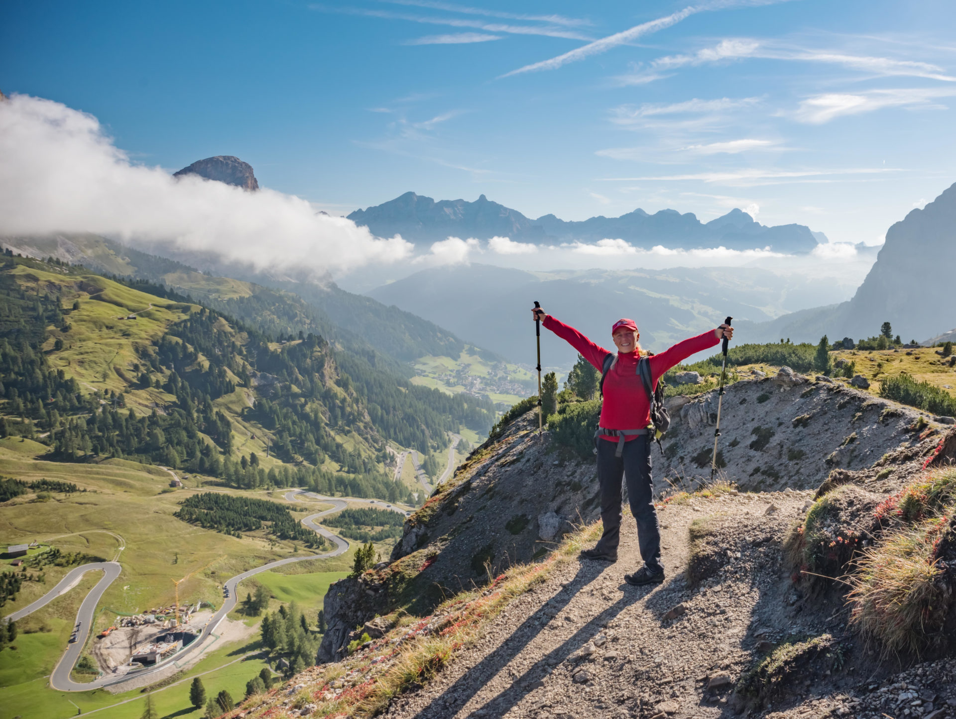 Hiker enjoying the view, looking at Dolomites mountains landscape.