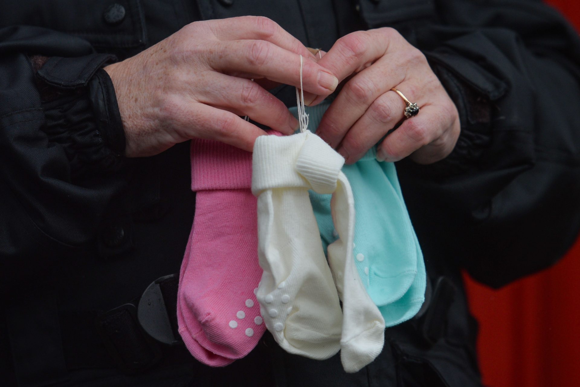 An activist holding children's socks during a virtual protest in front of the Irish Mother and Baby Home Commission's Office in Dublin. 