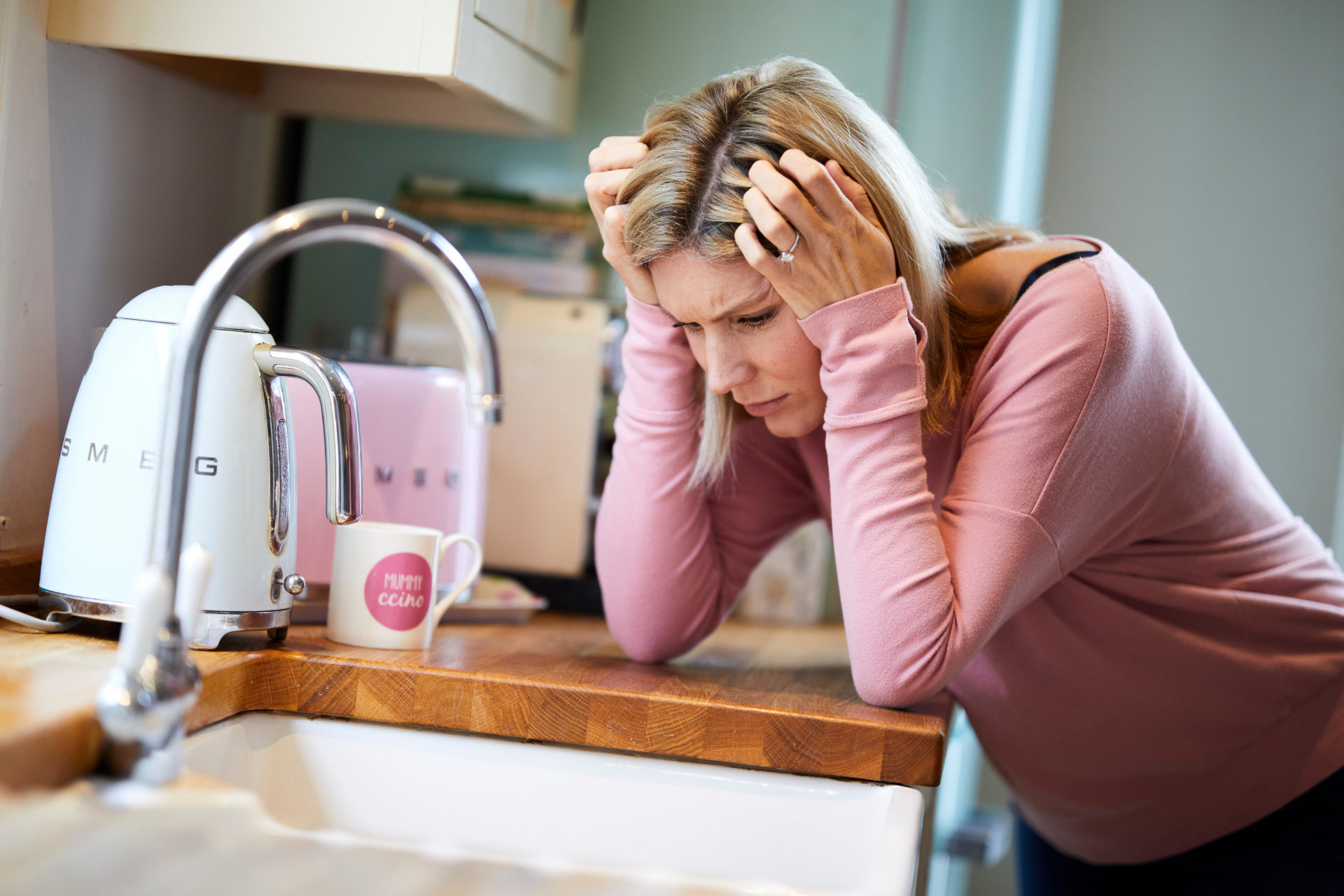 Stressed woman in the kitchen.