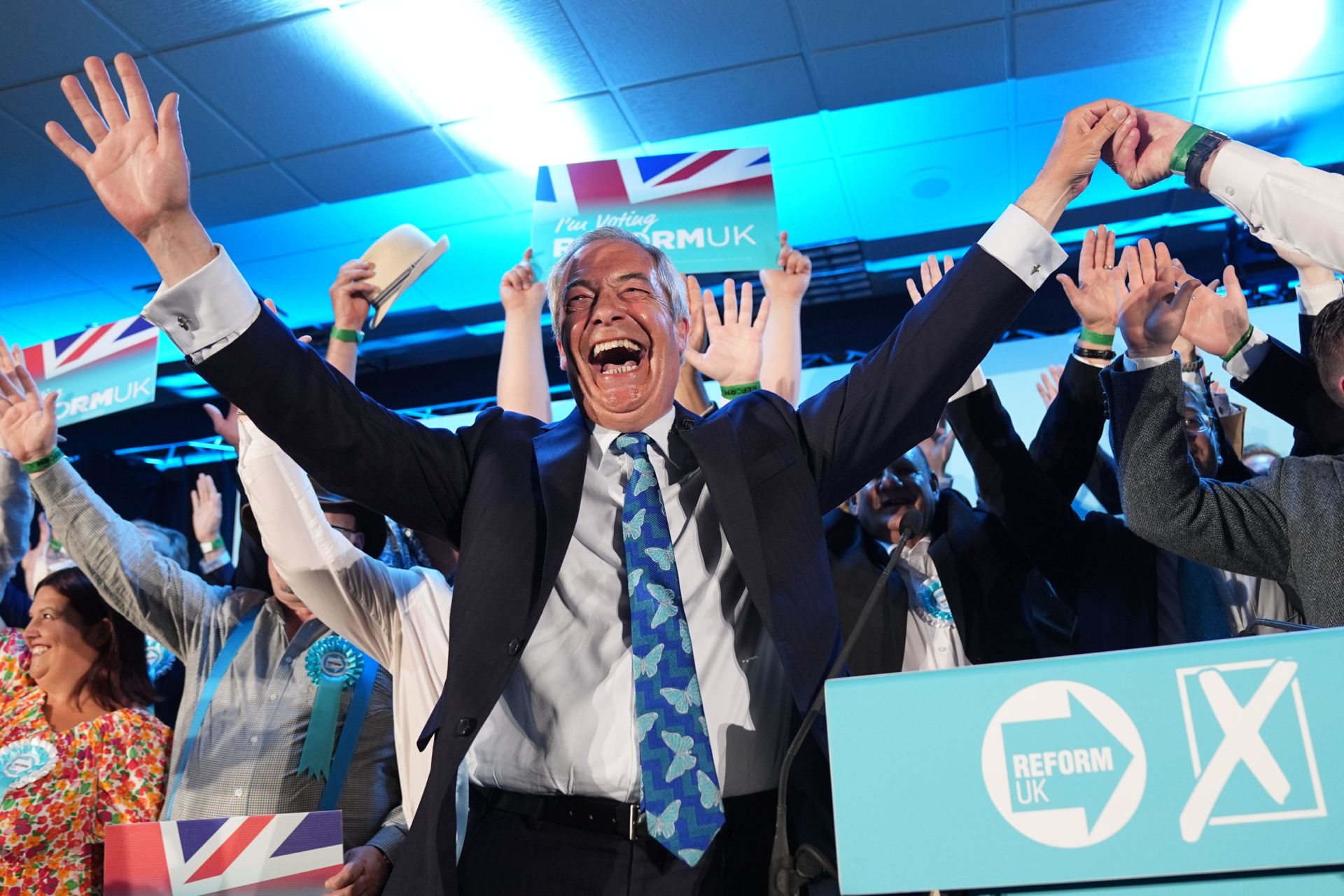 Reform UK party leader Nigel Farage with his party's candidates onstage during a campaign event at Stafford Showground.