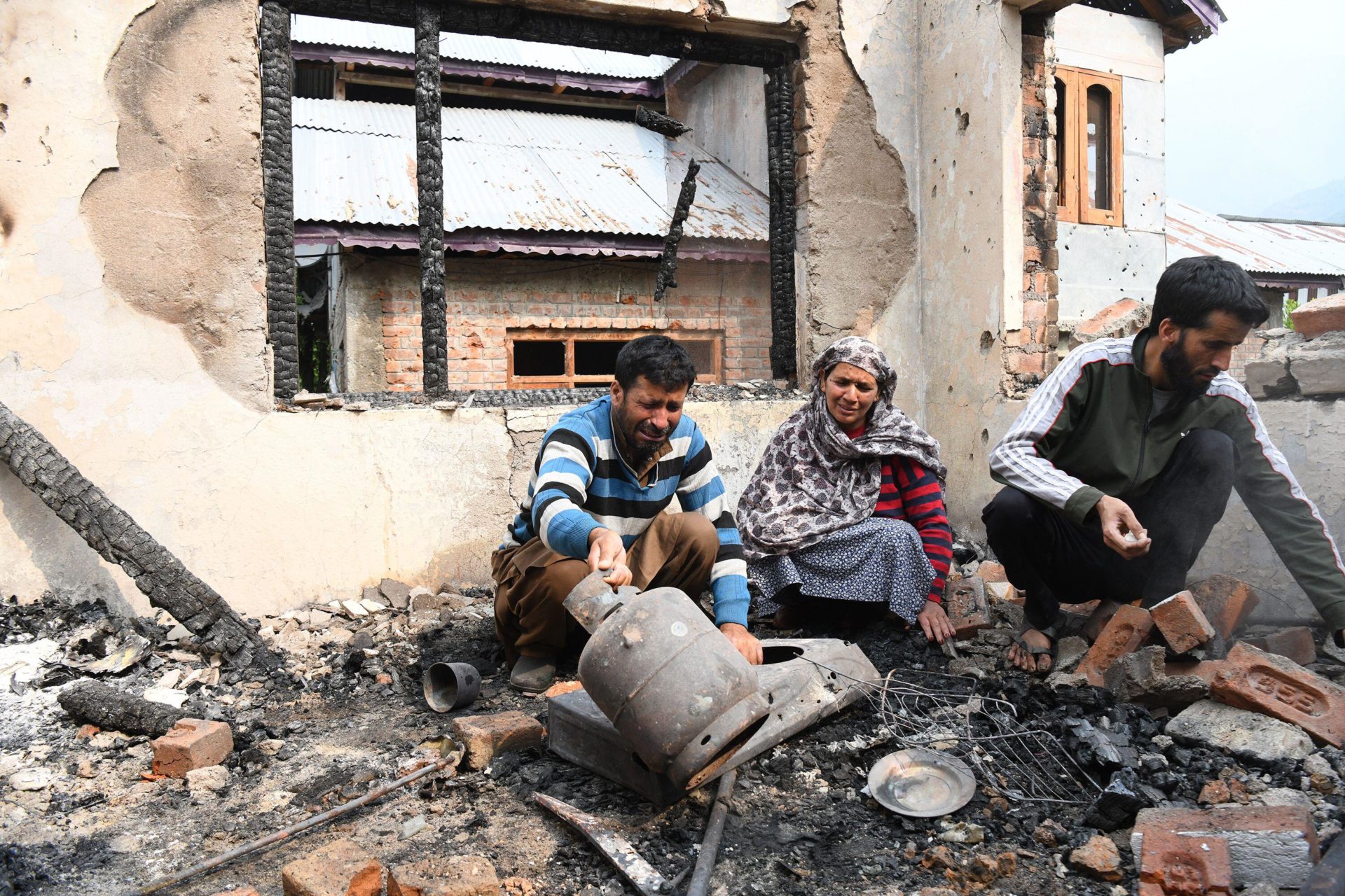 People inside a damaged house after shelling from Pakistan side following Indian Army's 'Operation Sindoor', in a village Salamabad URI near Line of Control Baramulla district.