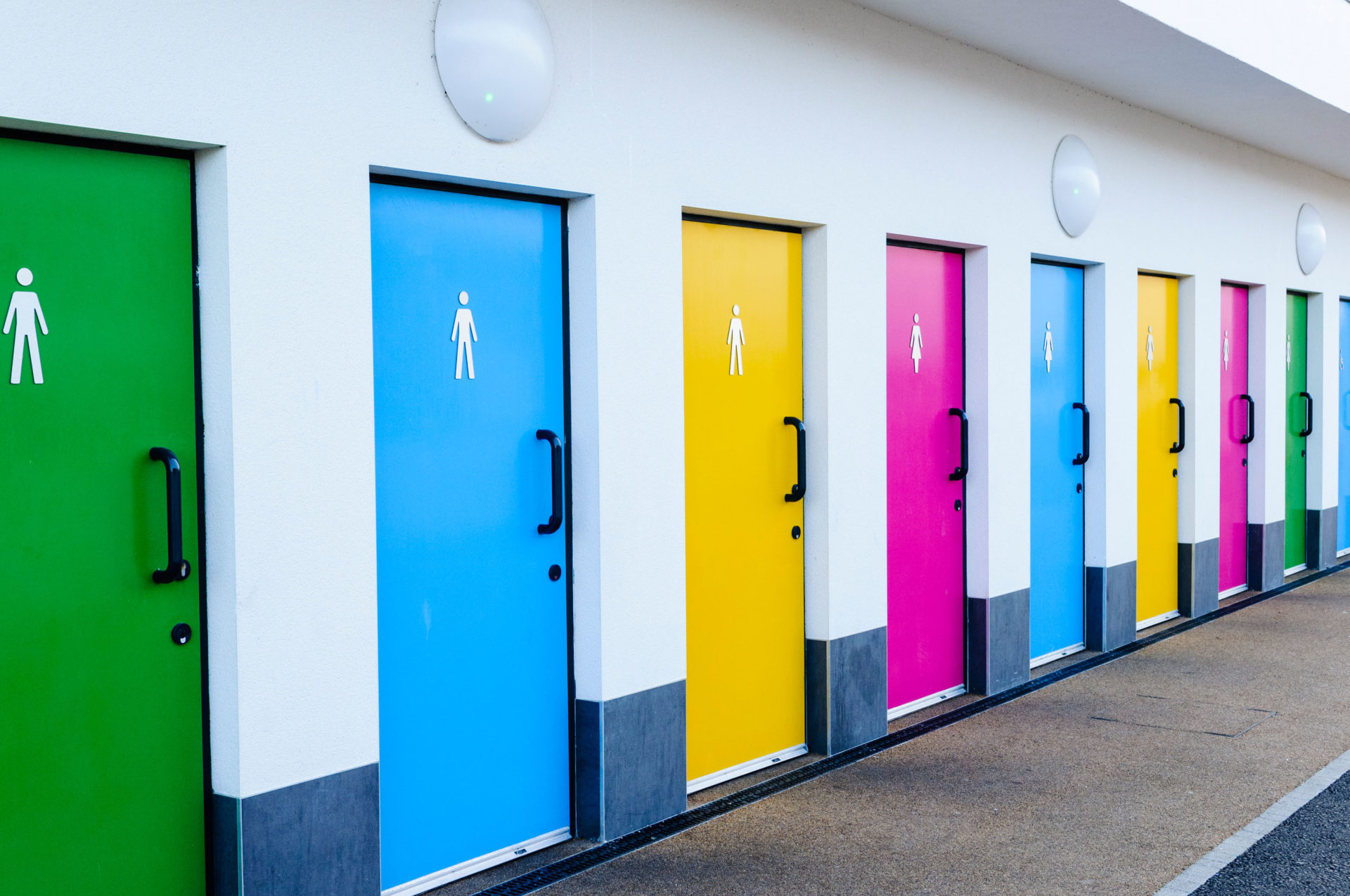 Brightly coloured public toilet doors.