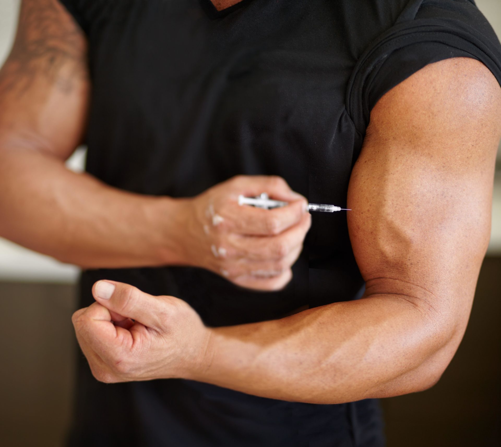 Arm, steroids and syringe with a bodybuilder man using a needle for a bicep muscle injection closeup.