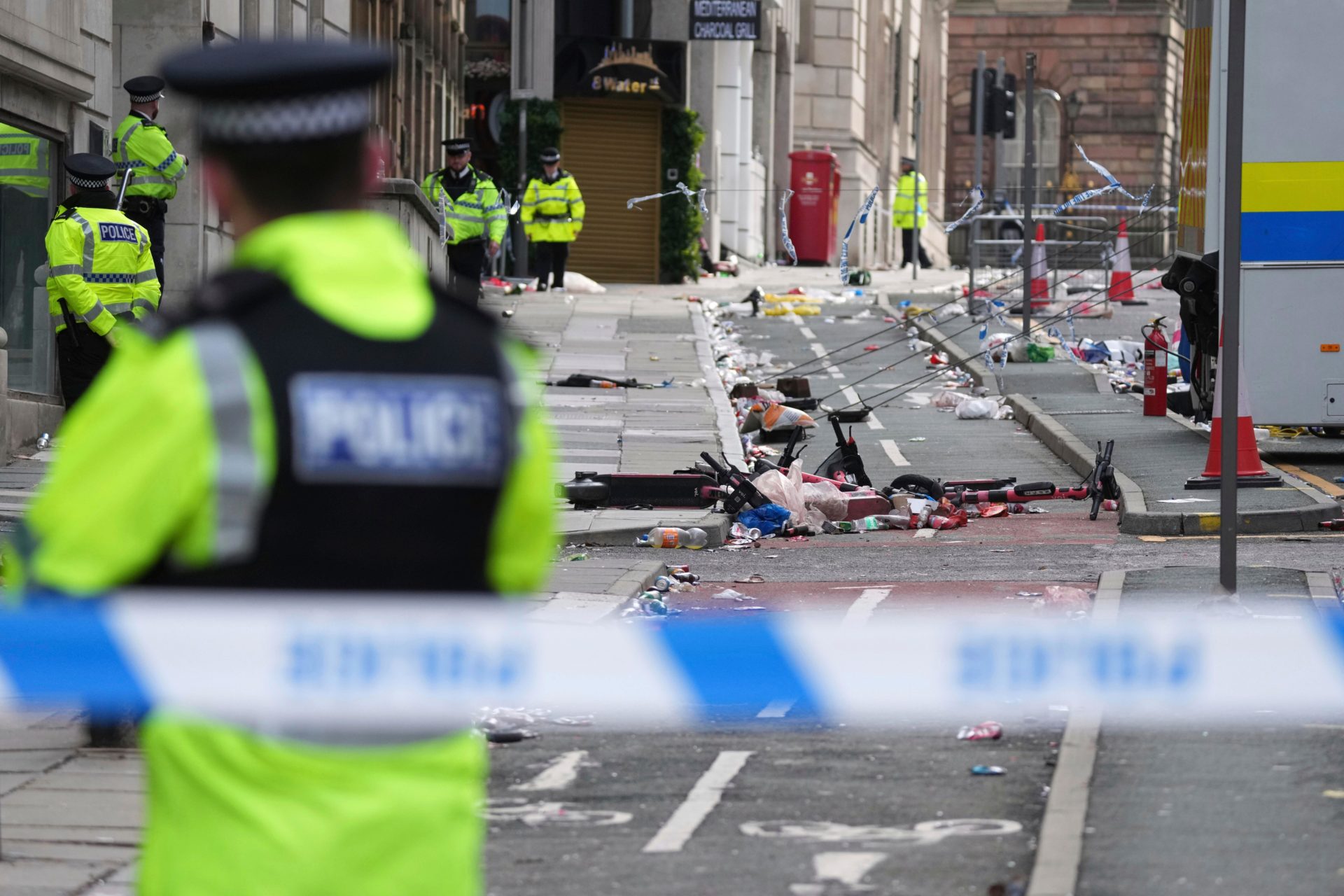 3BE1RJG Police guards the site where a 53-year-old British man plowed a minivan into a crowd of Liverpool soccer fans who were celebrating the city's Premier League championship Monday, injuring more than 45 people in Liverpool, England, Tuesday, May 27, 2025.(AP Photo/Jon Super)