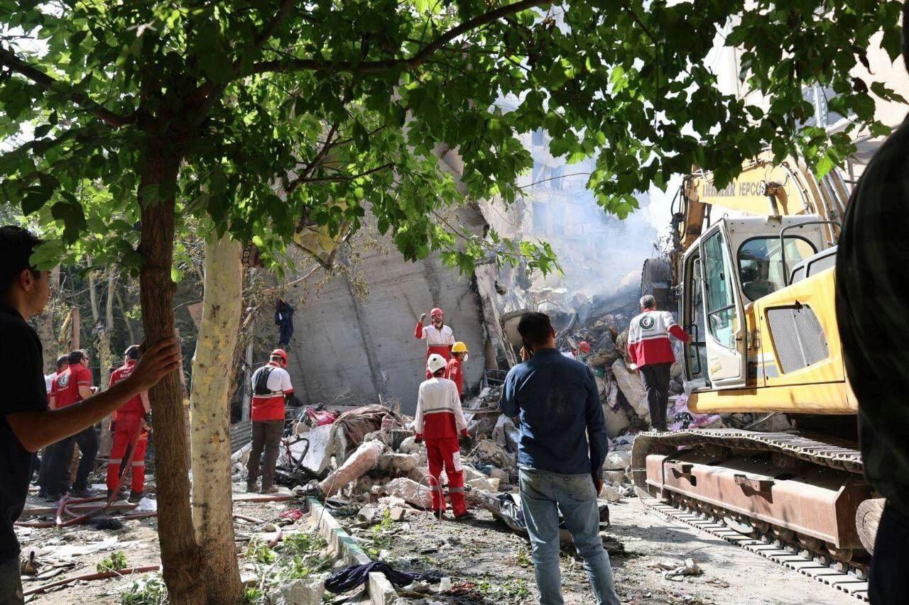 Rescuers work at the scene of an explosion after an Israeli strike in Tehran, Iran