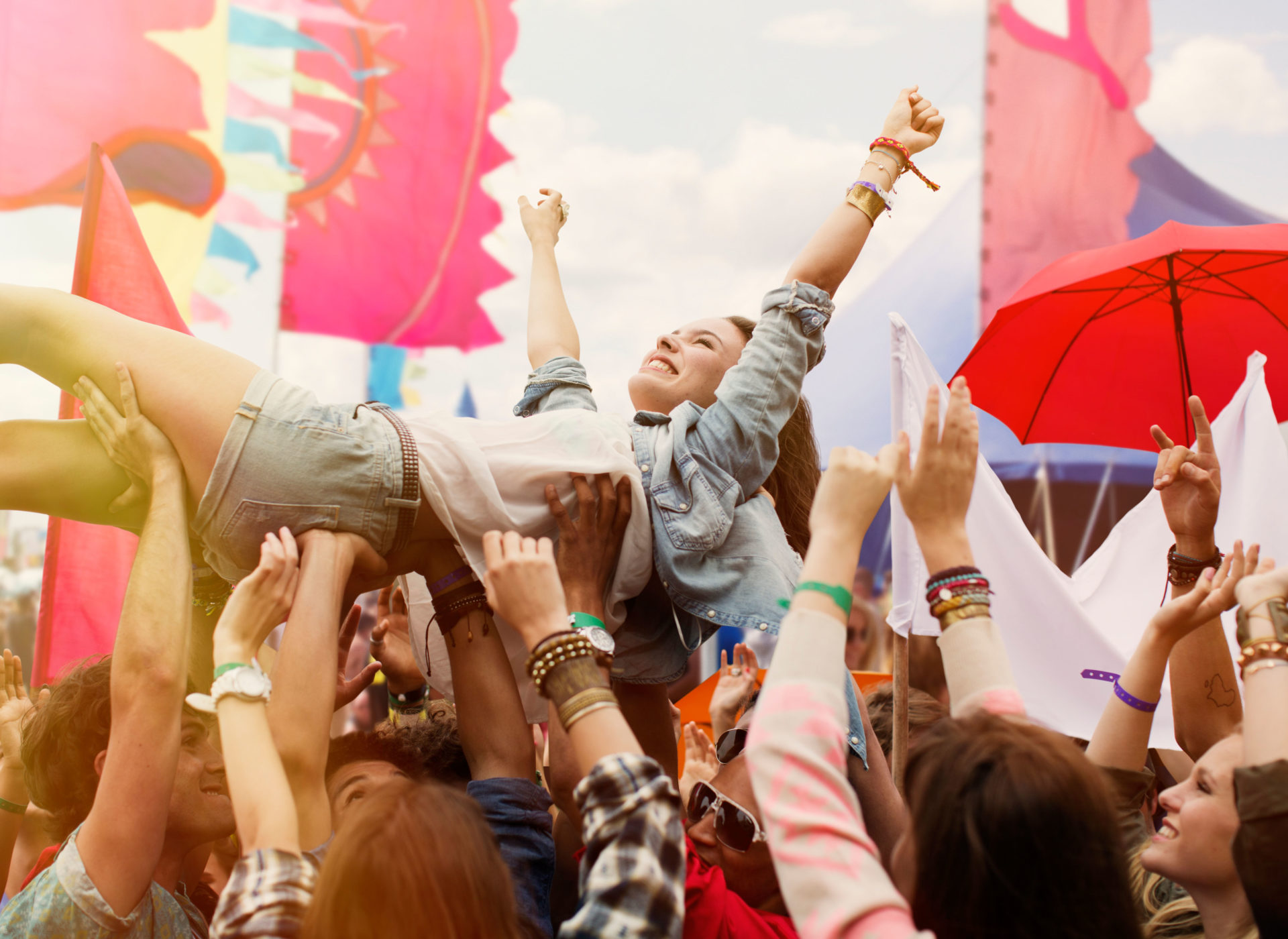 Woman crowd surfing at music festival.