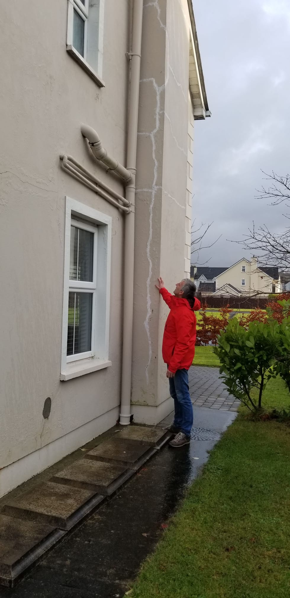 Professor Paul Dunlop oustide his home with mica. Image: Supplied. 
