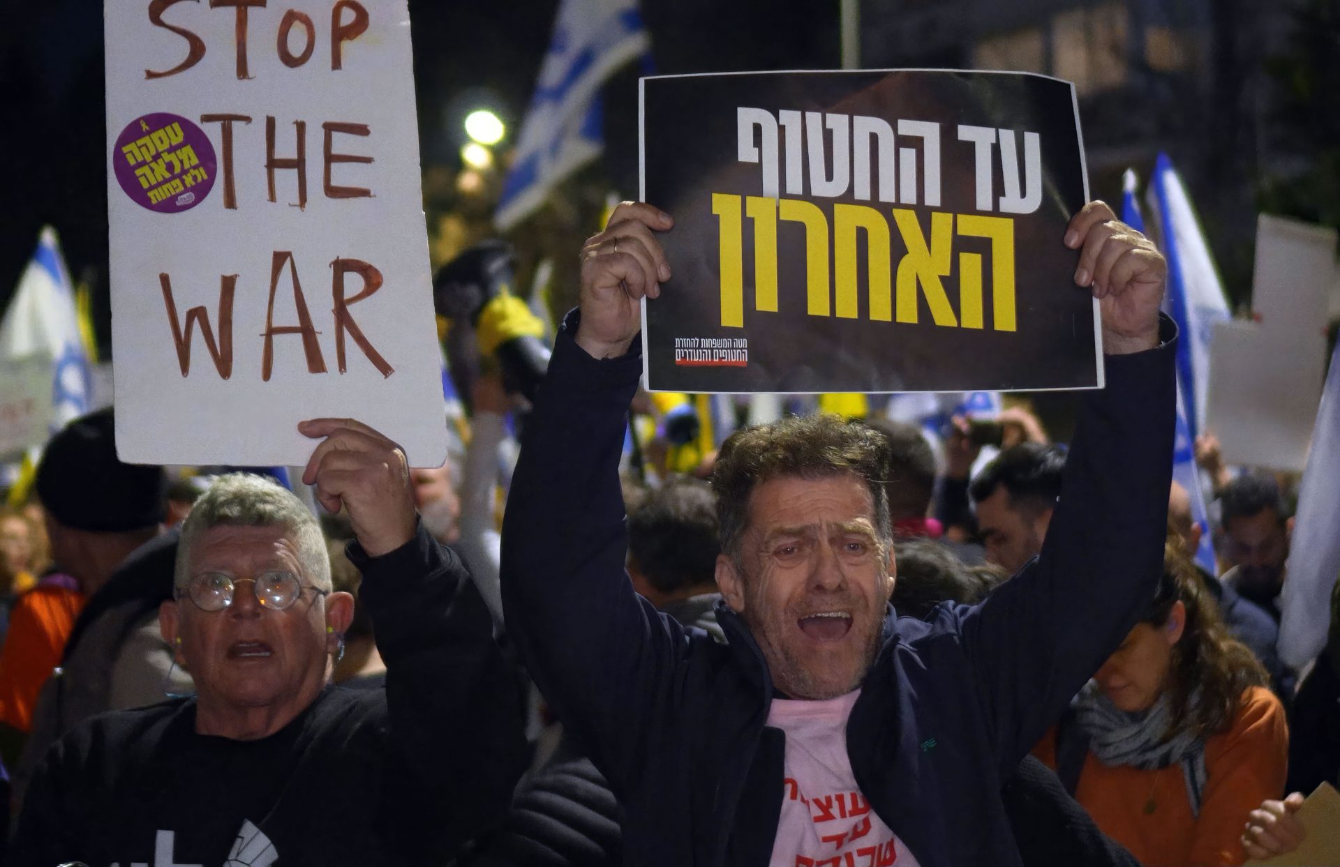 A demonstrator holds a sign that reads, "Stop the War" during an anti-government protest on March 2, 2025 in Jerusalem. 