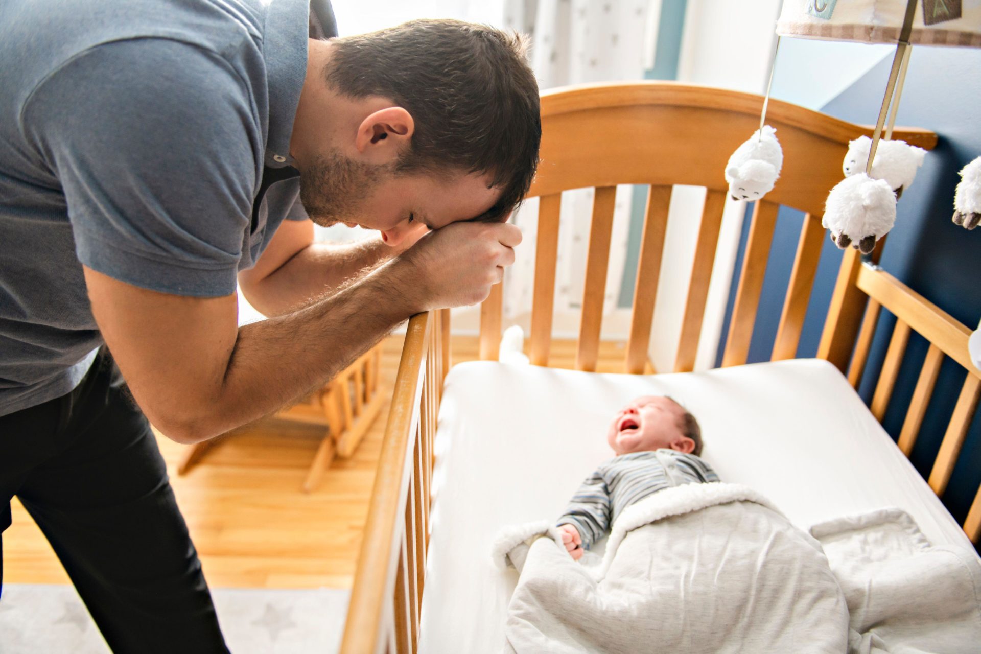 Tired father with upset baby. I
