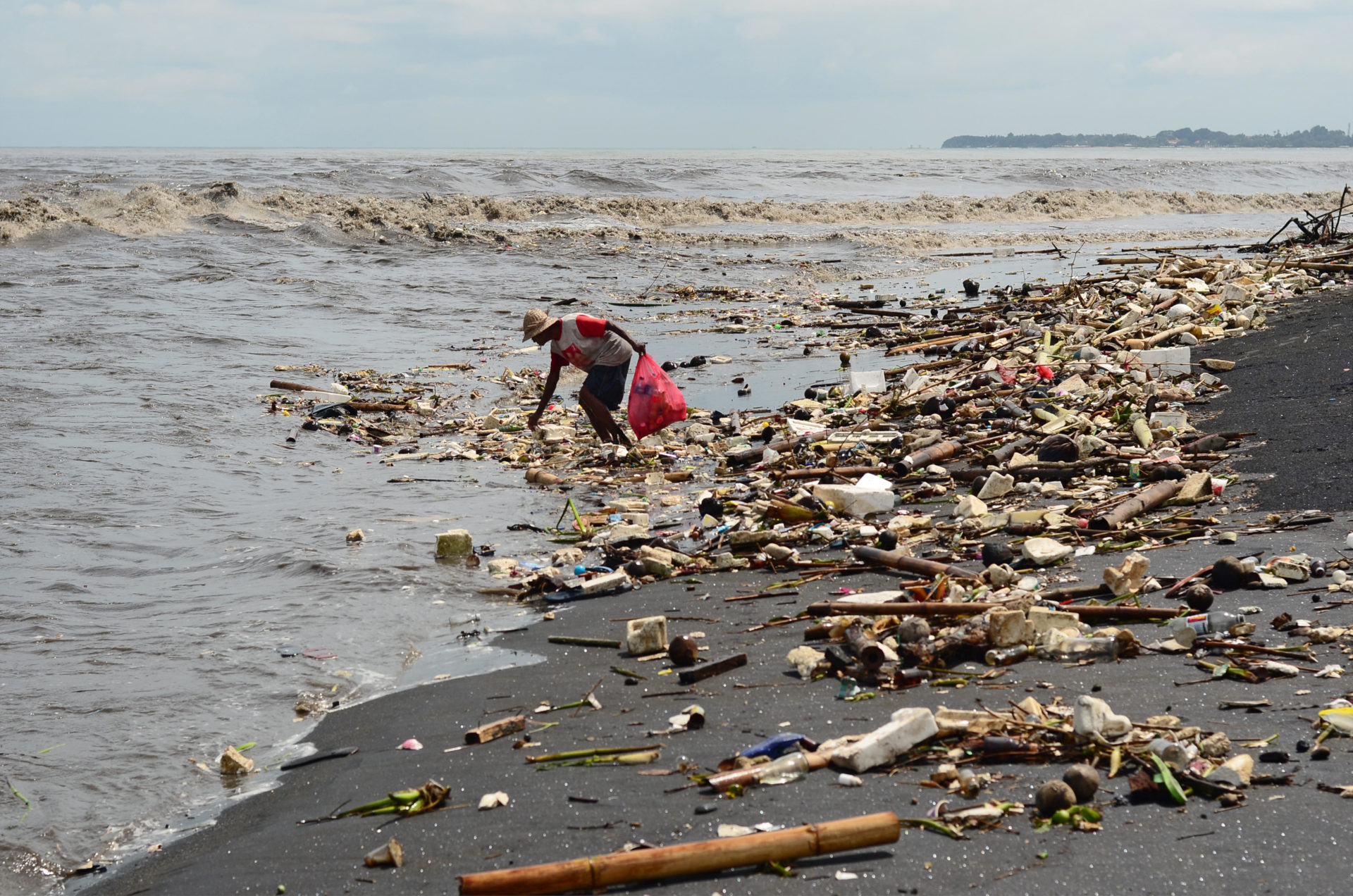 People Collecting Rubbish at Bali Beach during Monsoon. 