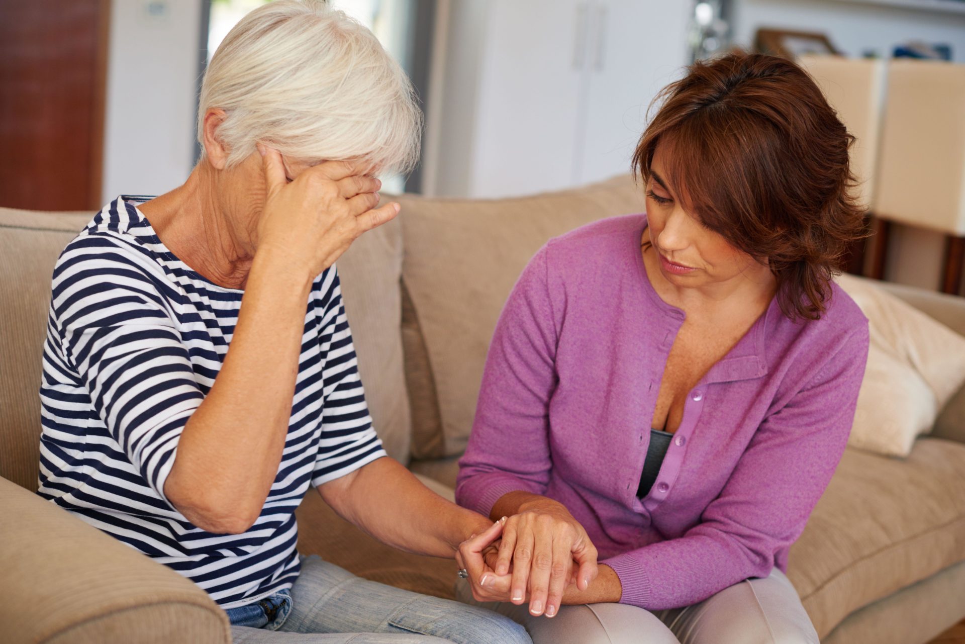 A woman comforting her elderly mother who's going through a tough time.