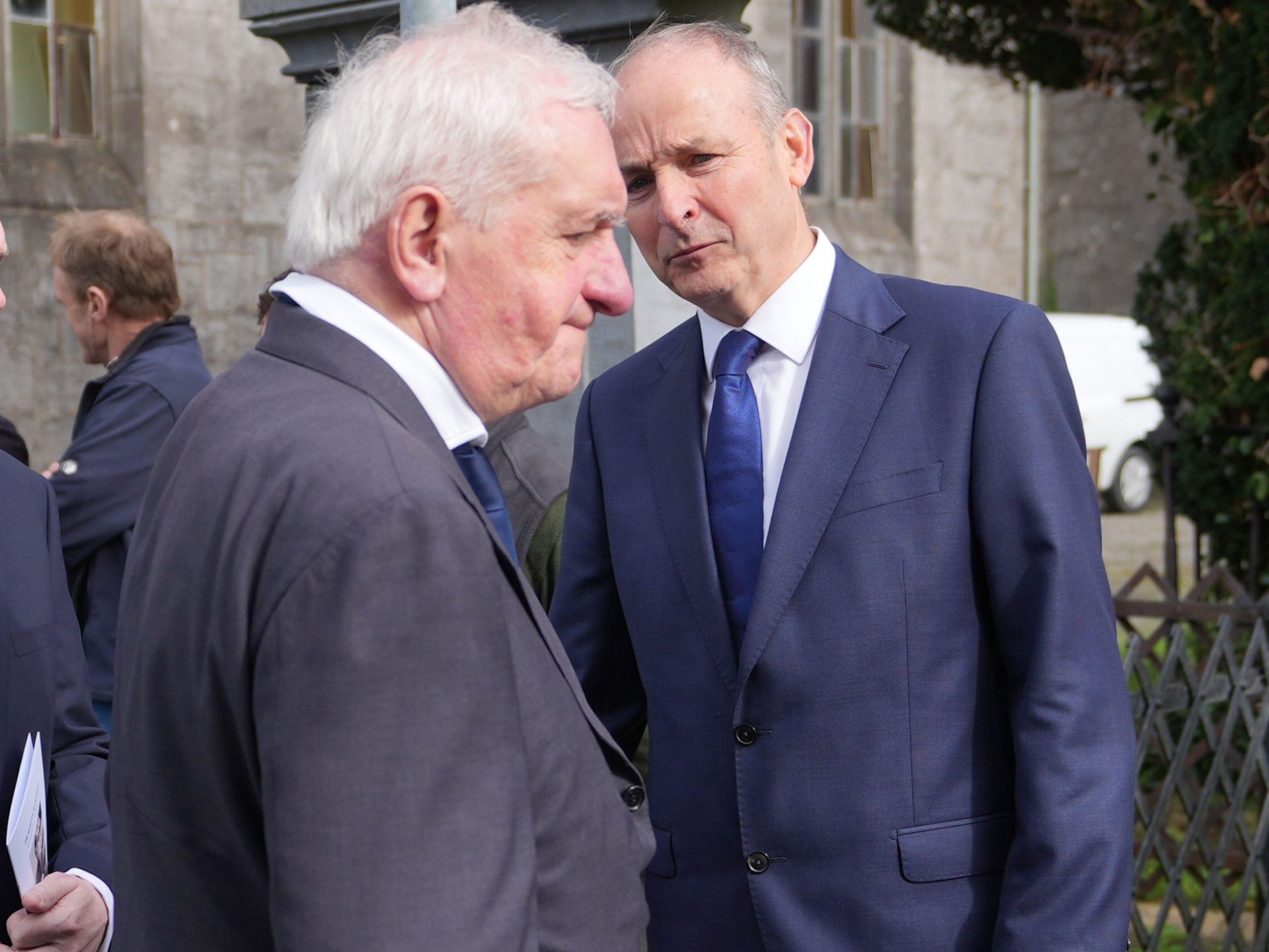 Taoiseach Micheál Martin (right) speaks to former Taoiseach Bertie Ahern after the funeral mass for Dr Martin Mansergh, at St. Mary's Church, Tipperary.