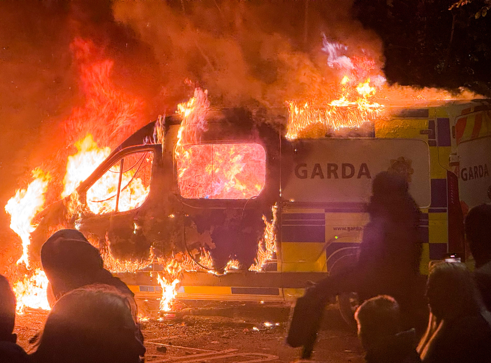 21/10/2025 Dublin, Ireland. A Garda van burns outside the Citywest Hotel in west Dublin, after being set fire during a protest linked to the alleged sexual assault of a young girl in the area. The demonstration, promoted by anti-immigration and far-right groups, saw fireworks set off and chants of “Get them out” directed at the asylum seeker accommodation centre. Photograph: Sasko Lazarov / © RollingNews.ie