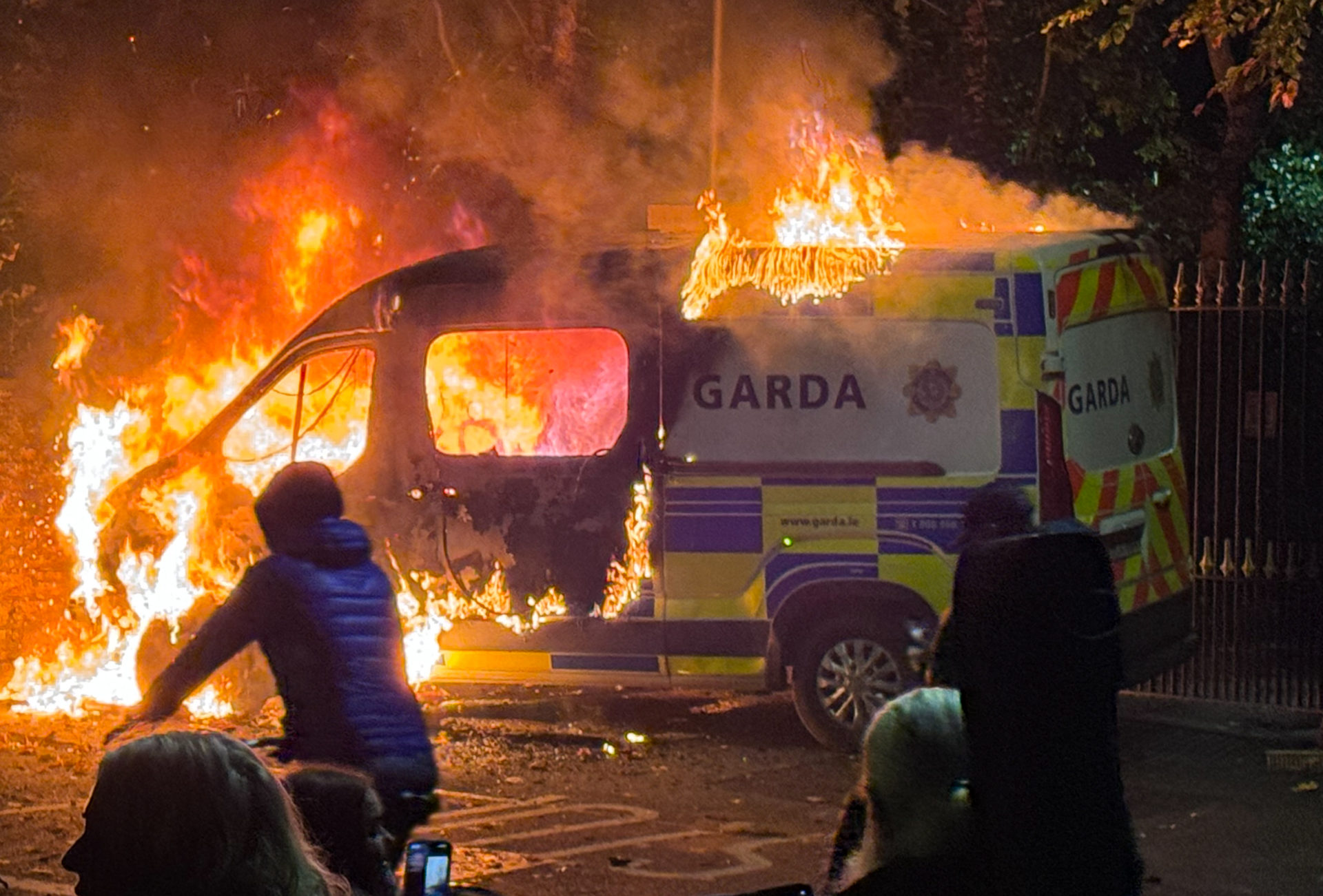 21/10/2025 Dublin, Ireland. A Garda van burns outside the Citywest Hotel in west Dublin, after being set fire during a protest linked to the alleged sexual assault of a young girl in the area. The demonstration, promoted by anti-immigration and far-right groups, saw fireworks set off and chants of “Get them out” directed at the asylum seeker accommodation centre. Photograph: Sasko Lazarov / © RollingNews.ie