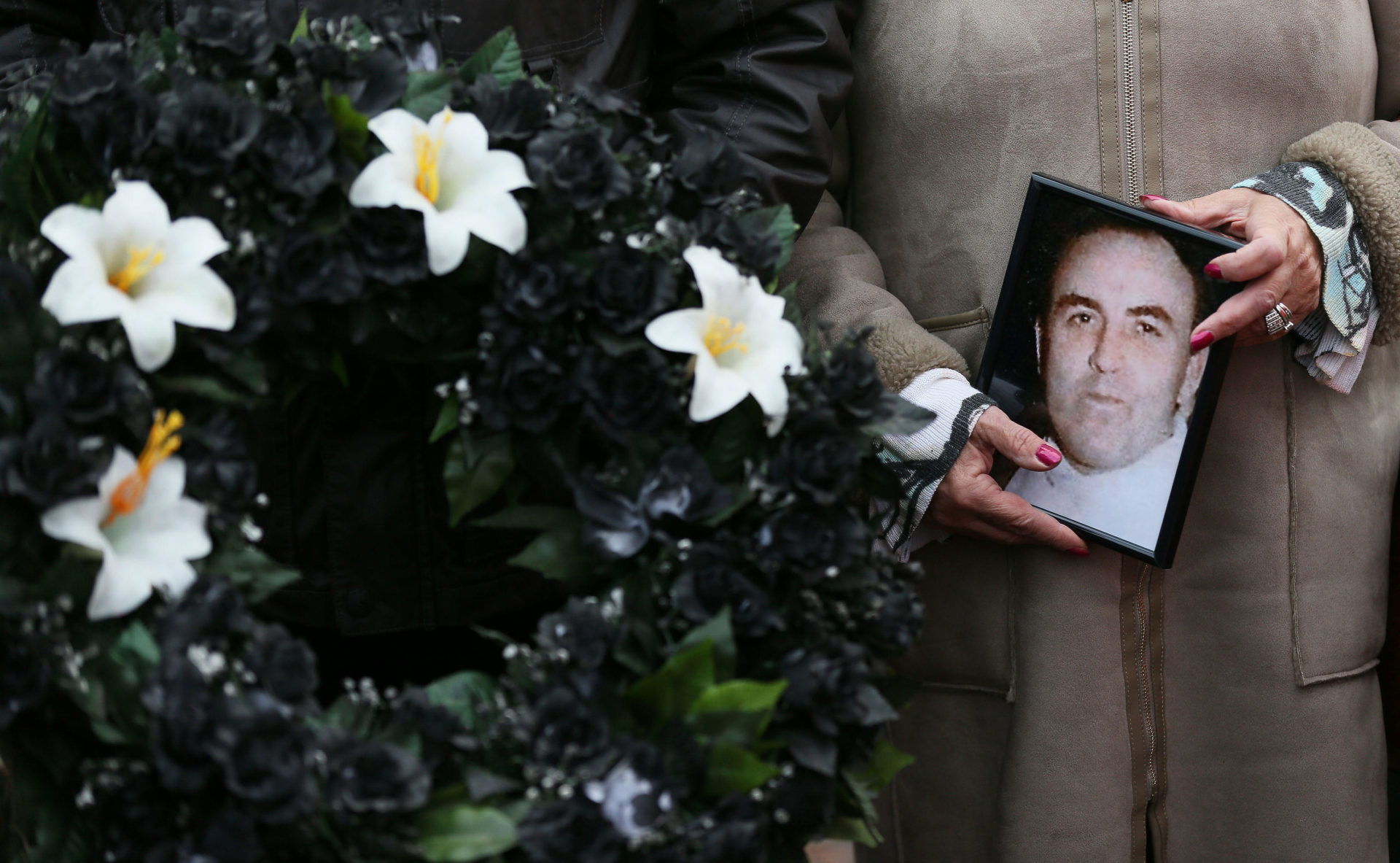 KG0XN8 Marie Lynskey holds a photograph of her uncle Joe Lynskey, one of the disappeared, during the 11th annual 'Silent Walk for the Disappeared' to remember victims of Northern Ireland's Troubles at Stormont, Belfast.