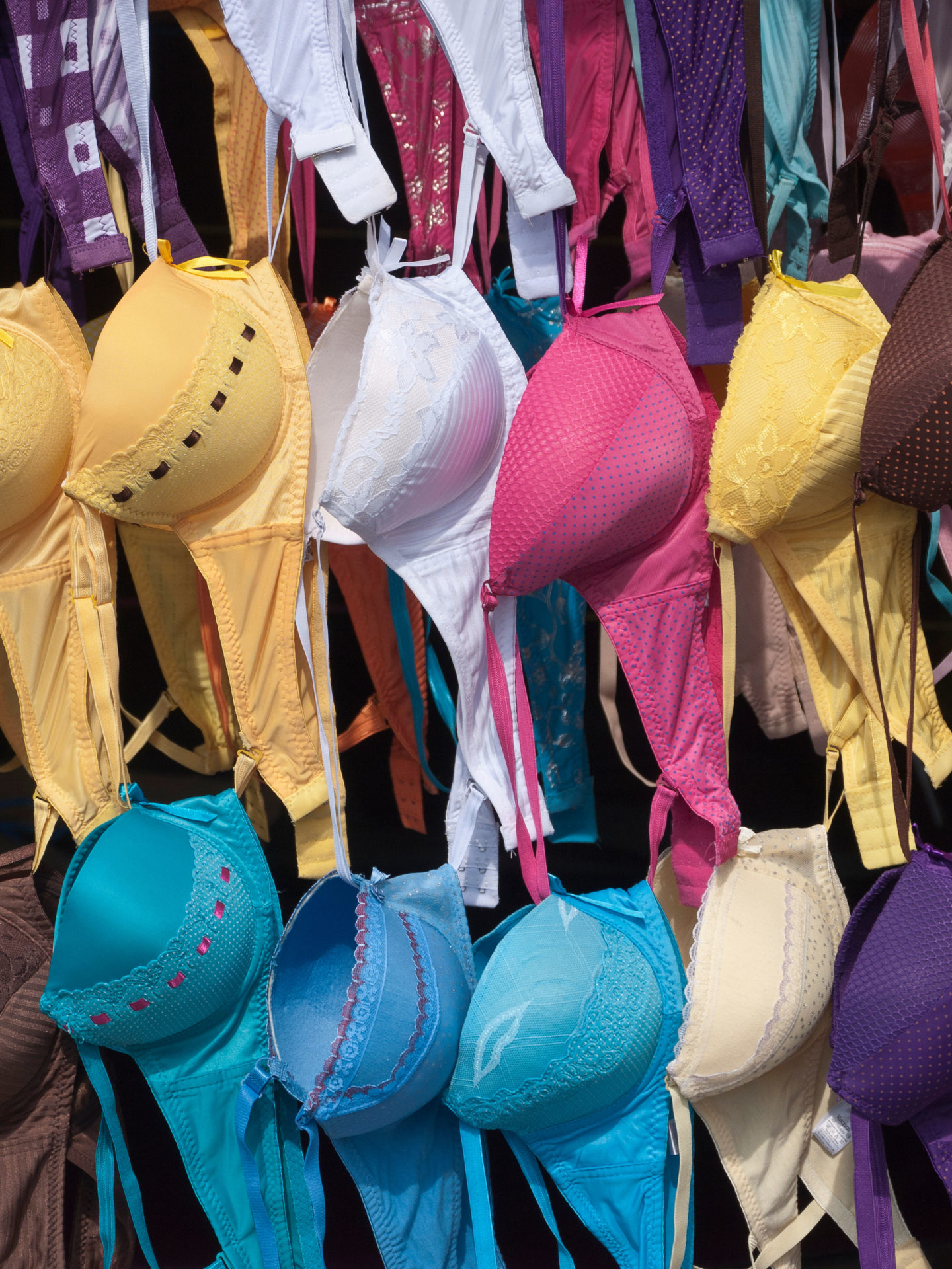 C2FT9M A colorful and graphic repetition of form in a display of women's bras on sale at the public market in Antigua, Guatemala.